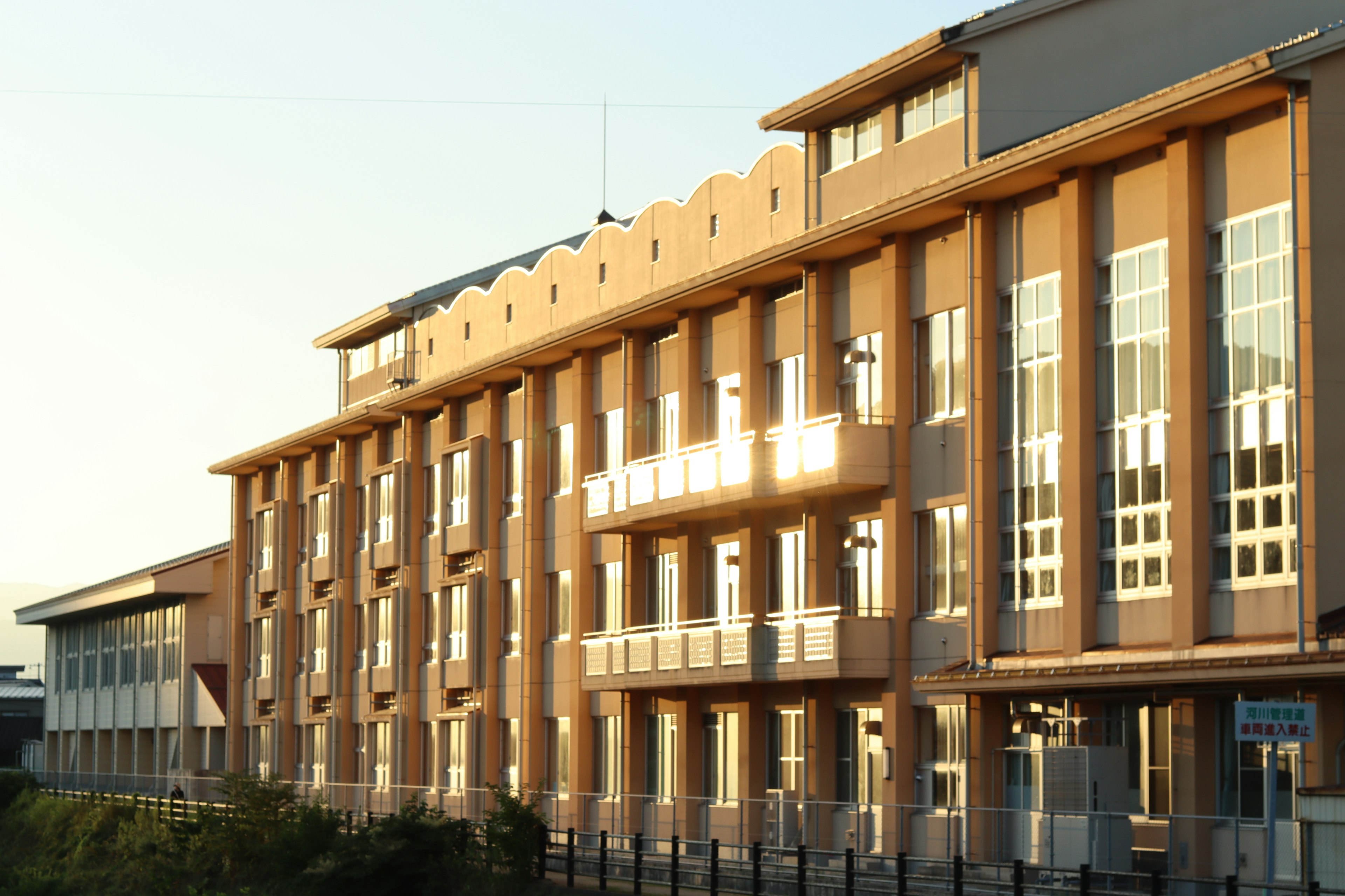 Modern building facade illuminated by sunset