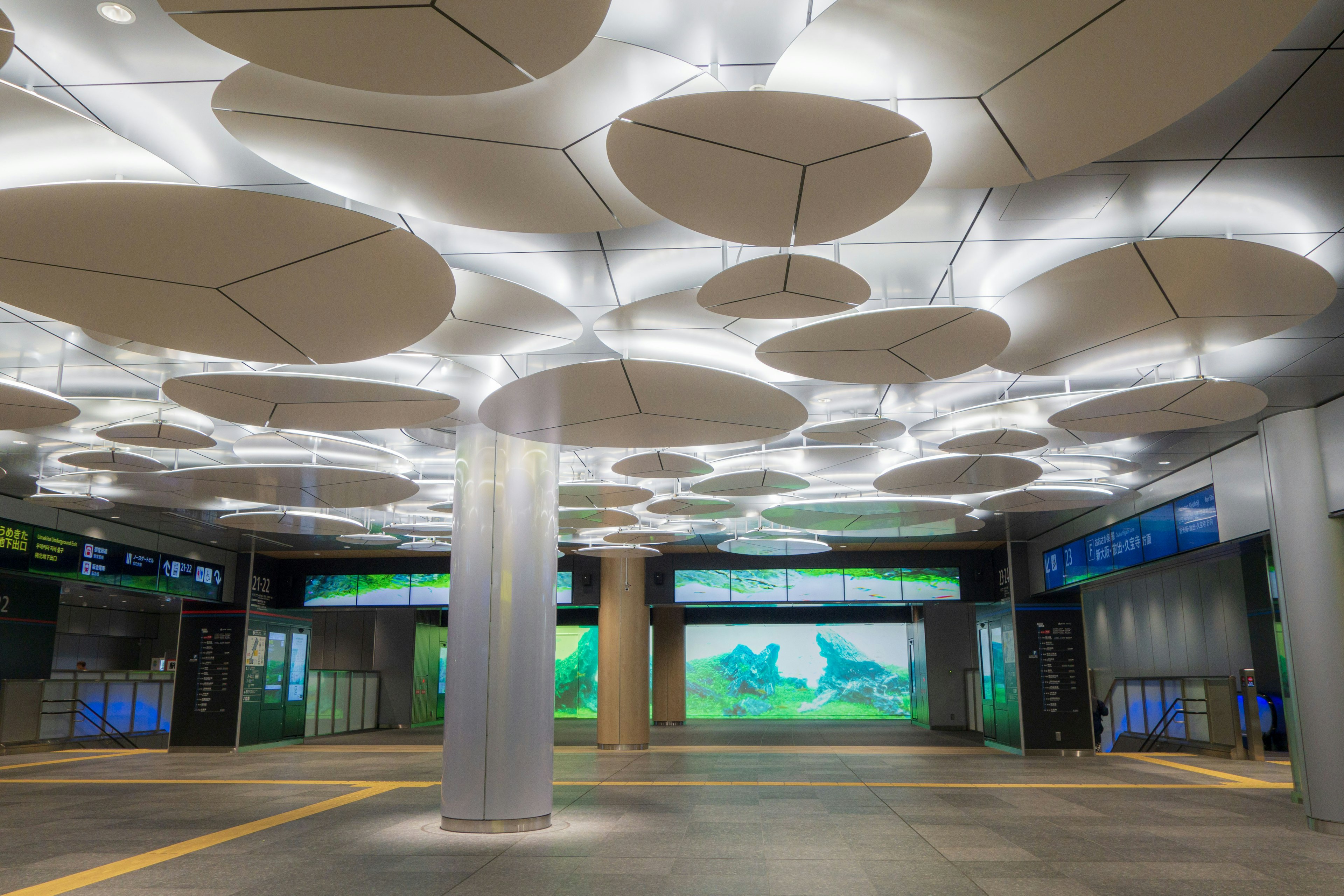 Modern station interior featuring bright lighting and circular ceiling design