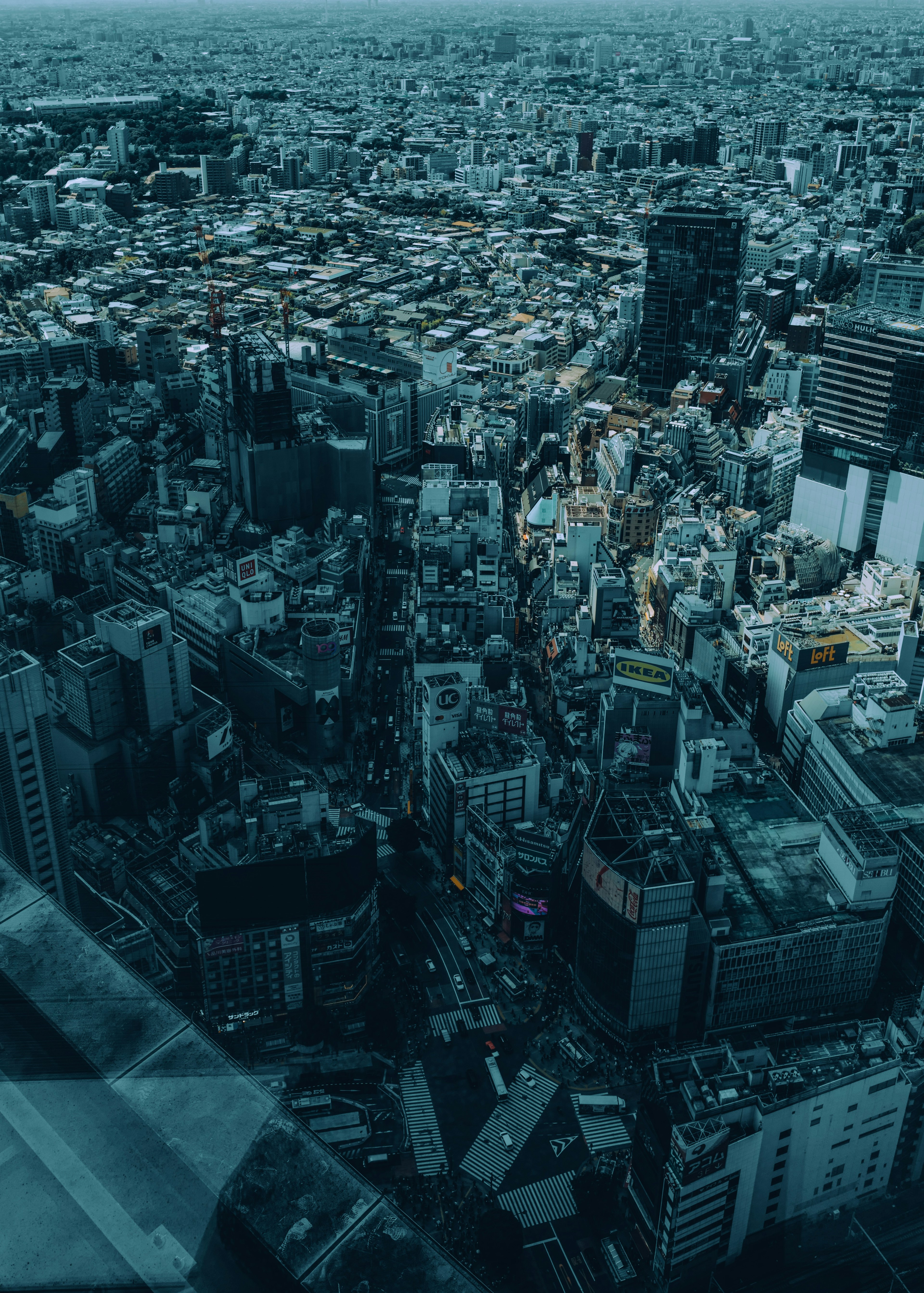 Aerial view of a cityscape featuring various buildings and streets