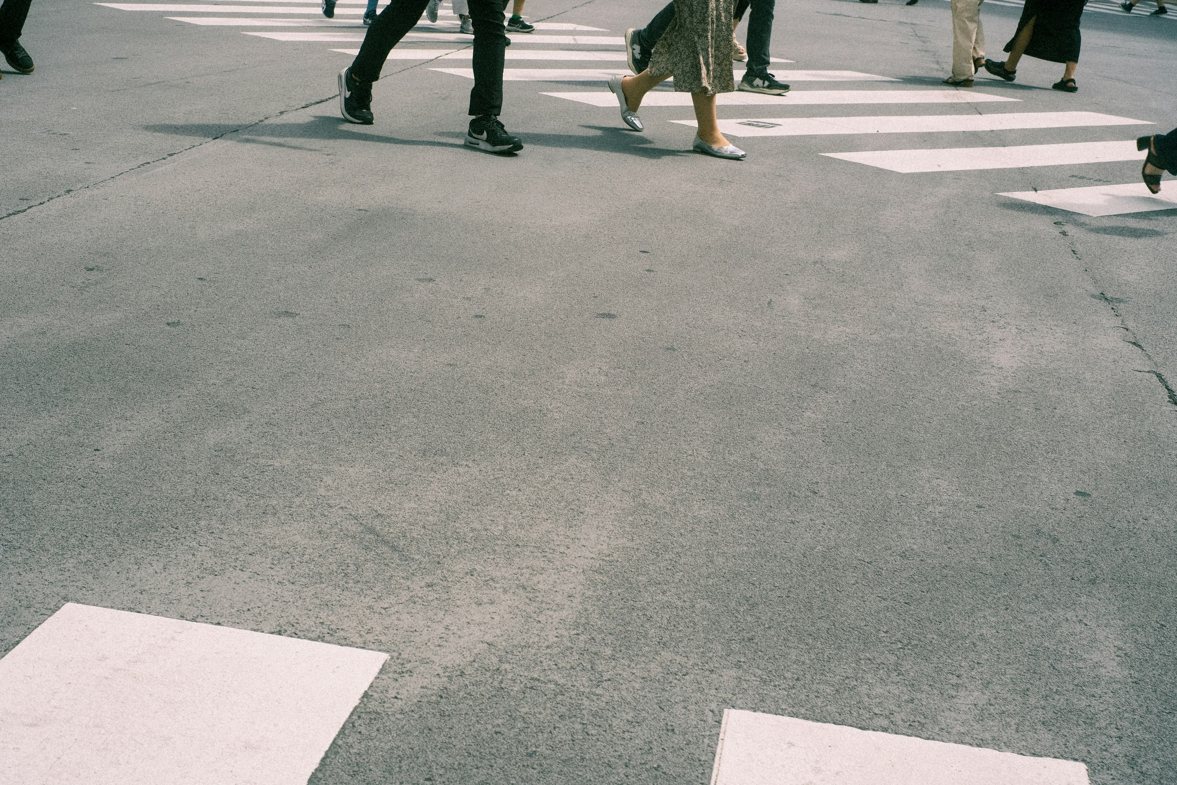 View from below of people crossing a crosswalk