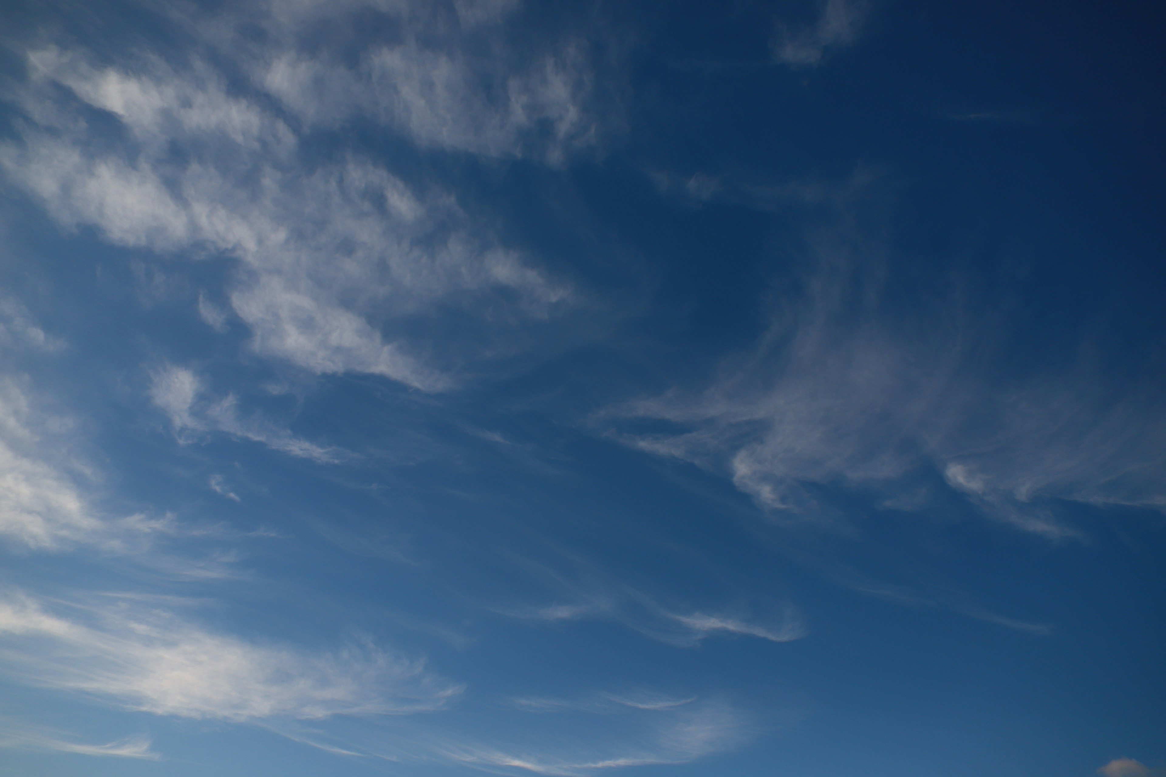 A wide view of clouds flowing in a blue sky