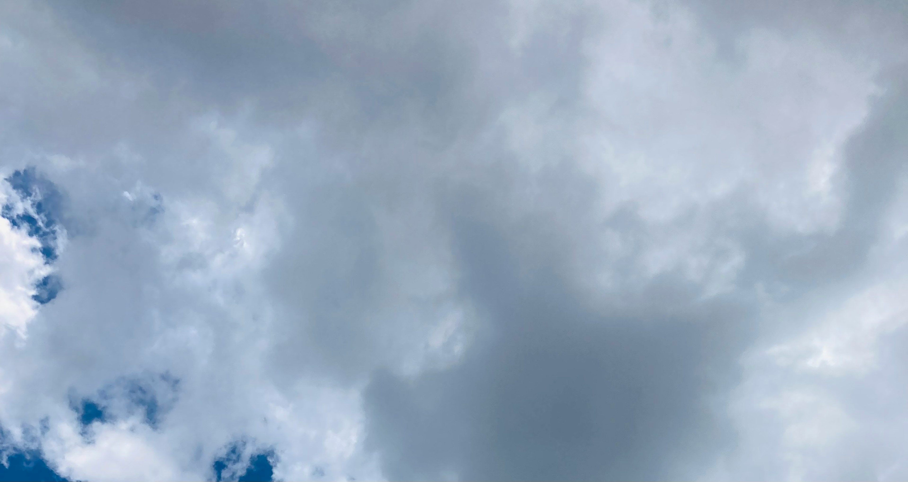 Gray clouds with patches of blue sky