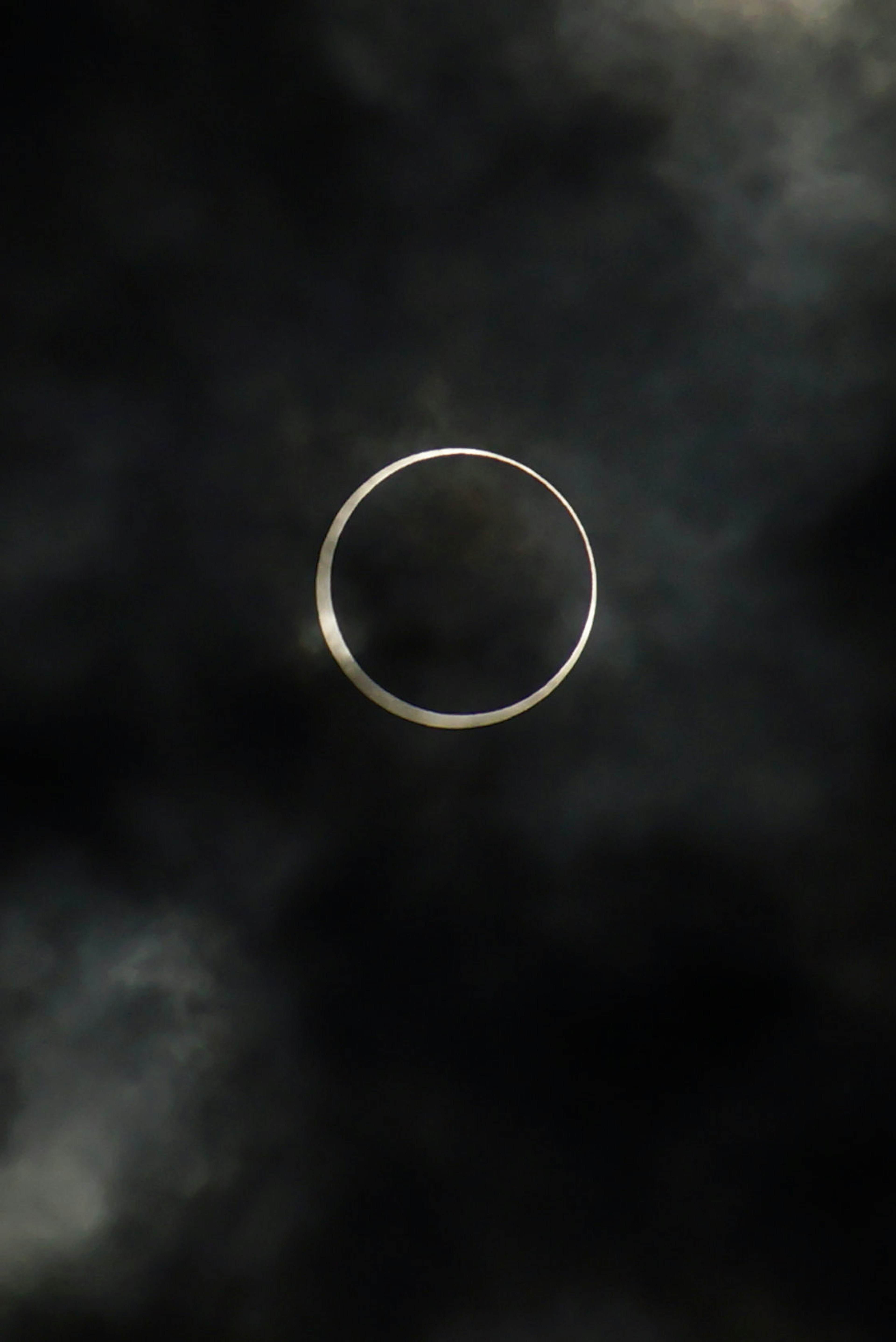 Thin ring of light surrounded by dark clouds