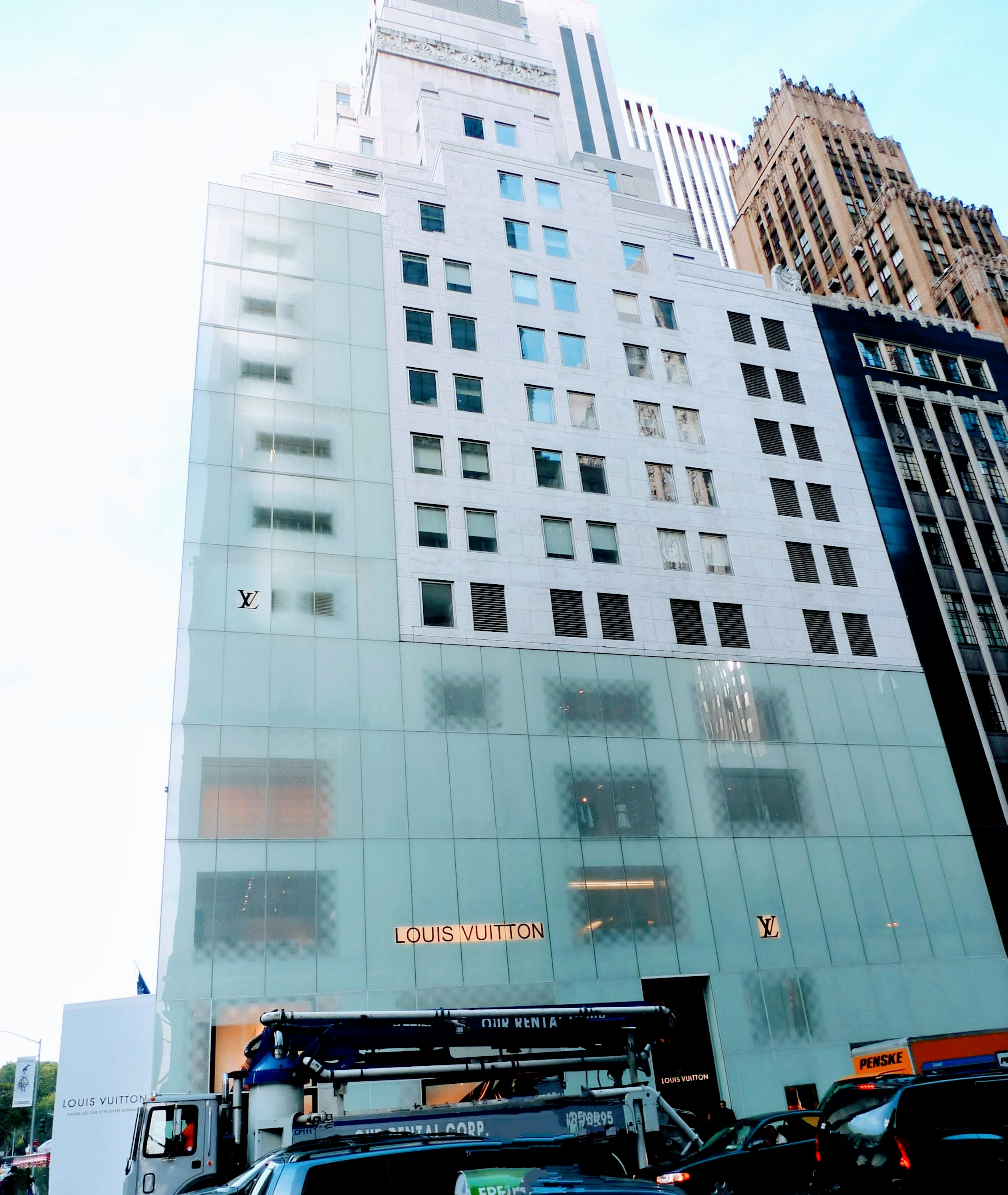 Urban landscape featuring a building with a distinctive glass facade