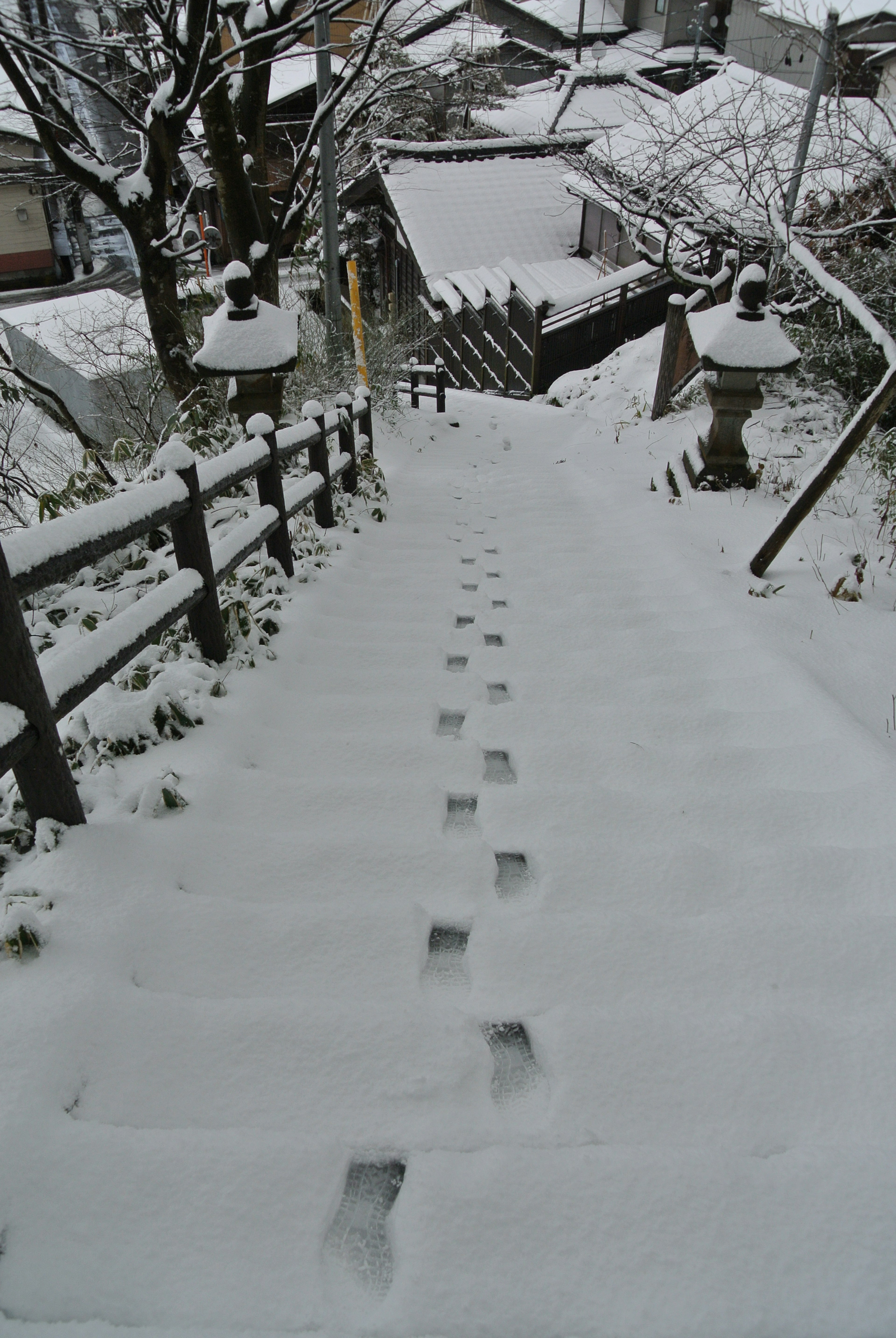 Snow-covered stairs with visible footprints