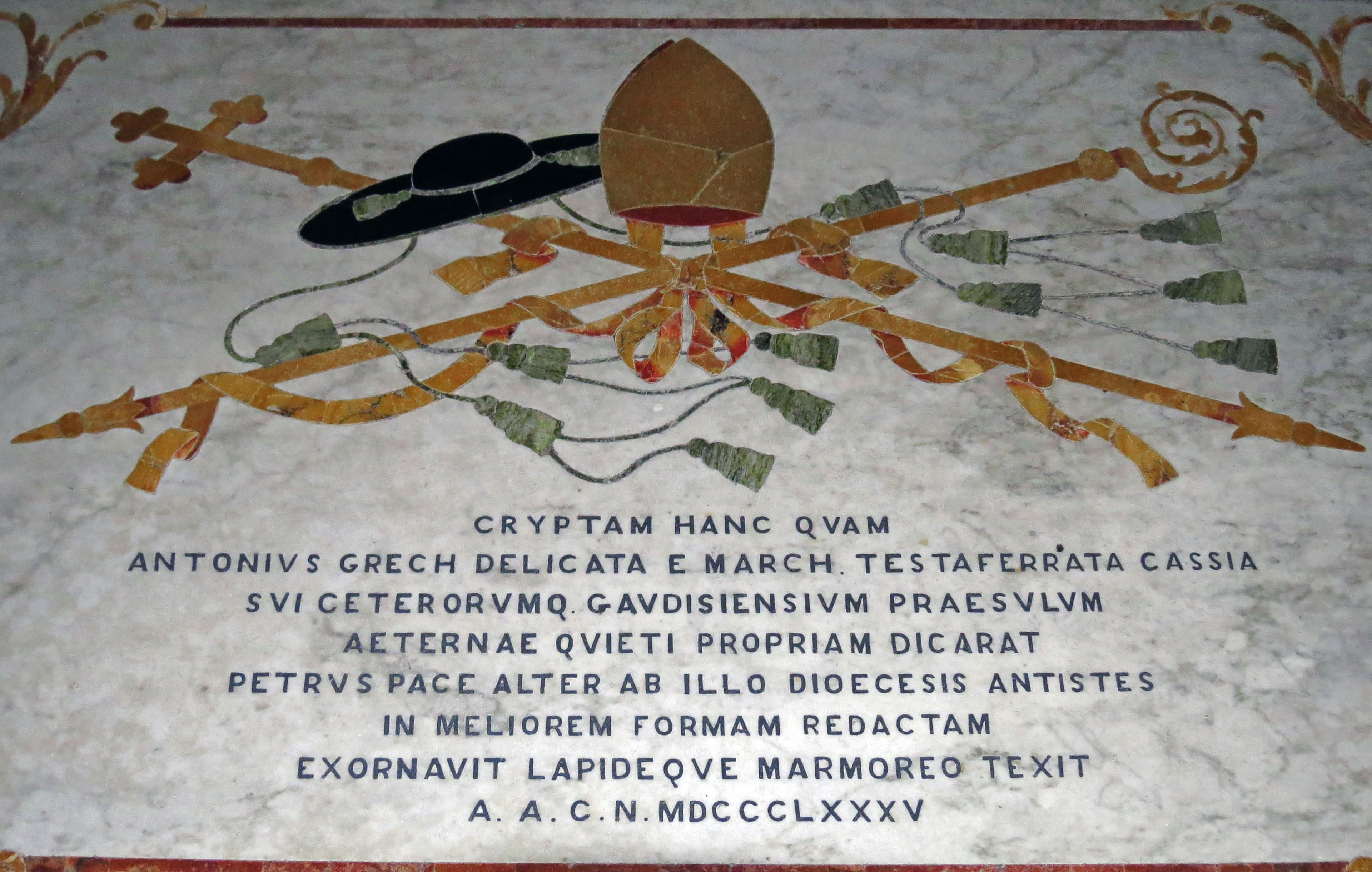 Inscription and emblem on a stone slab featuring Latin text