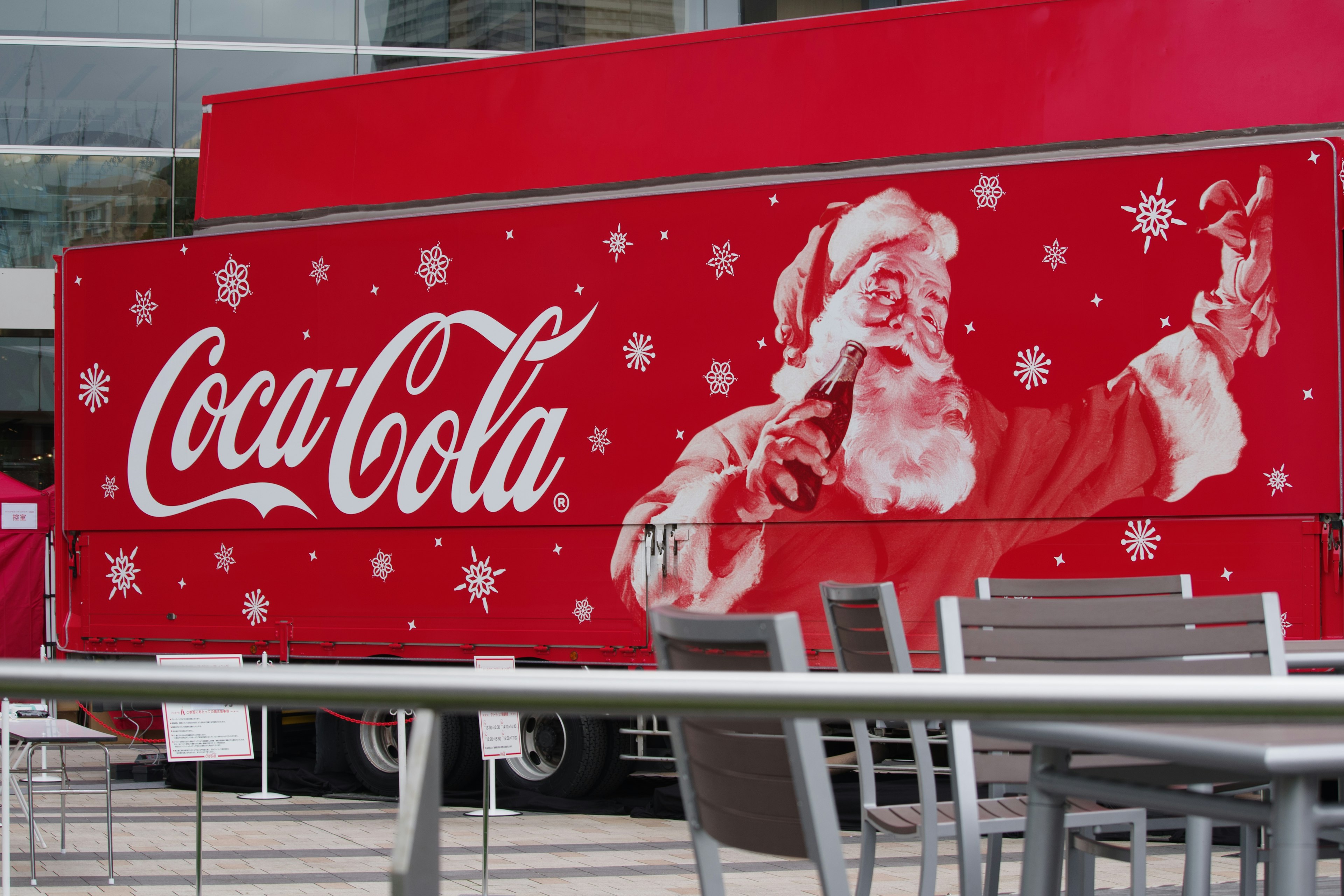 Coca-Cola truck featuring Santa Claus illustration with snowflakes