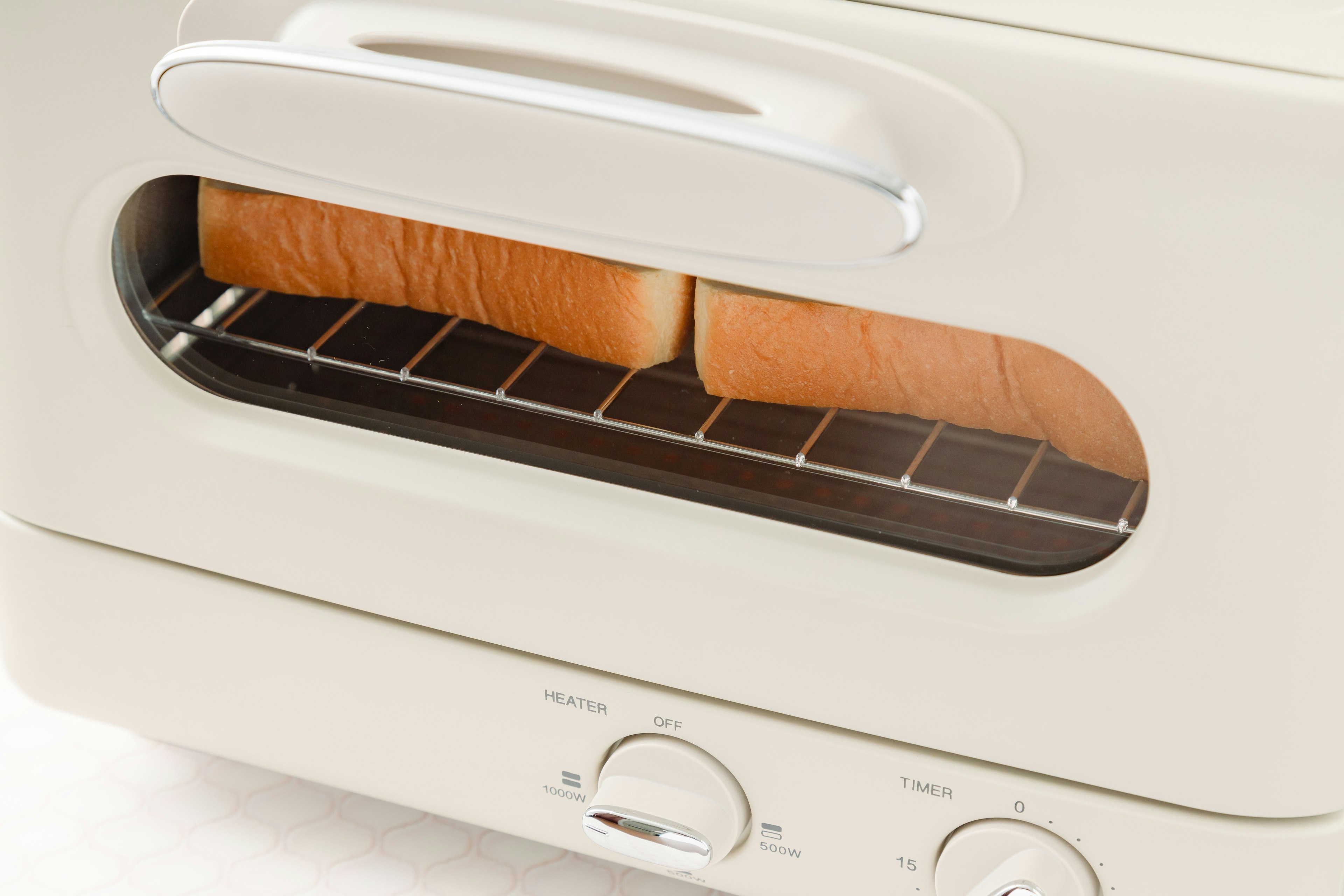 Toaster with two slices of perfectly toasted bread visible inside