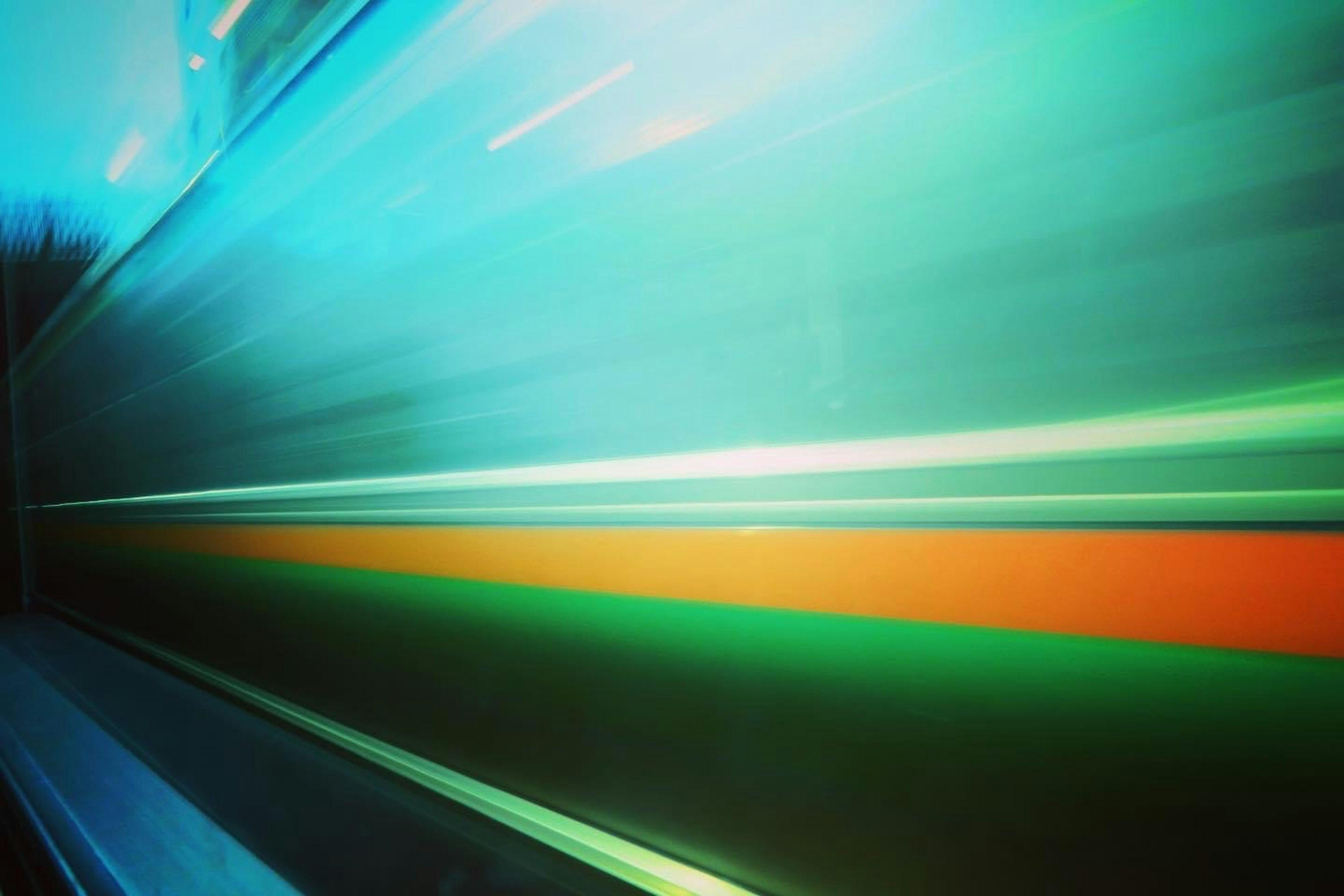 Motion blur of a train with blue and green lights