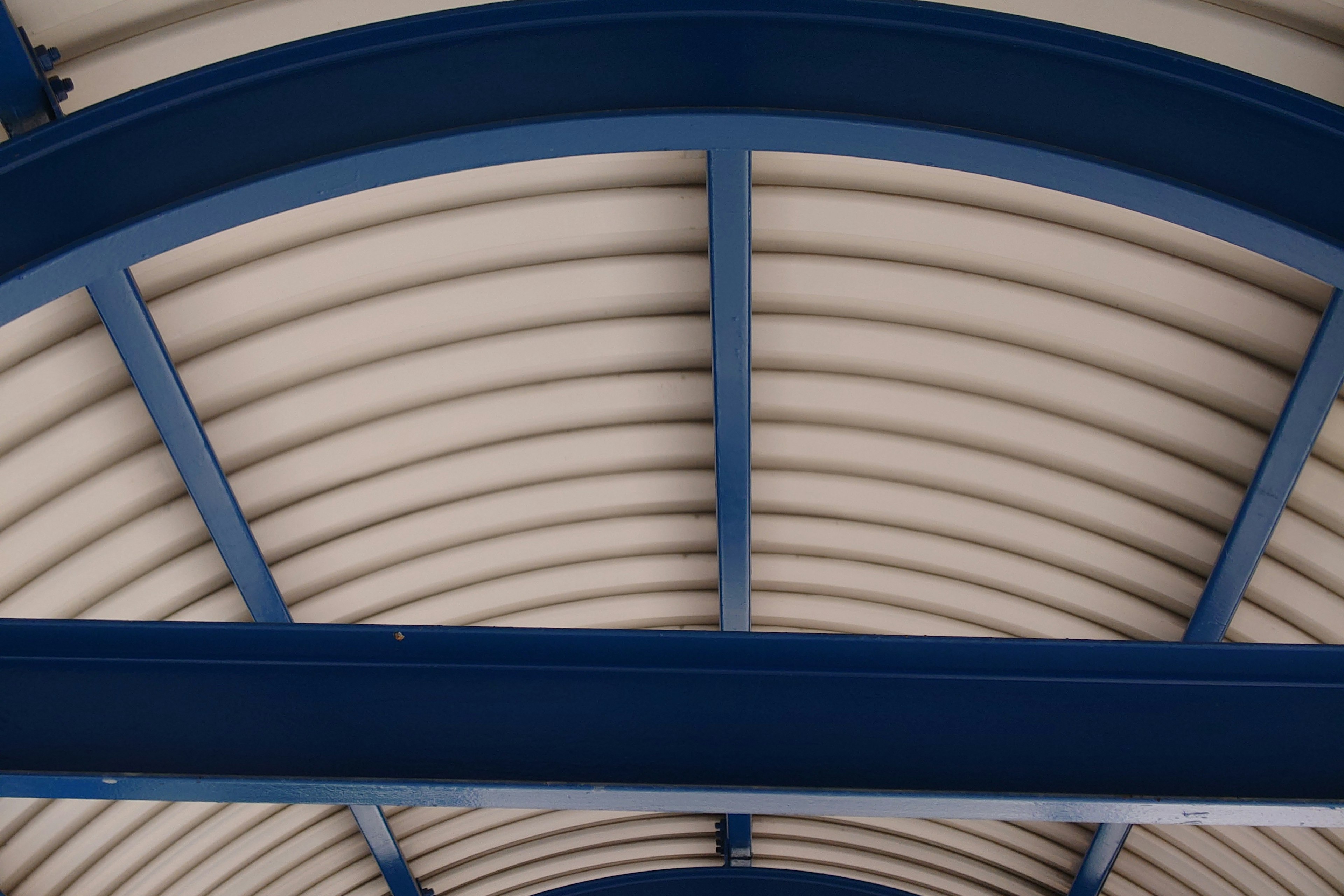 Interior of a wavy roof with blue metal framing