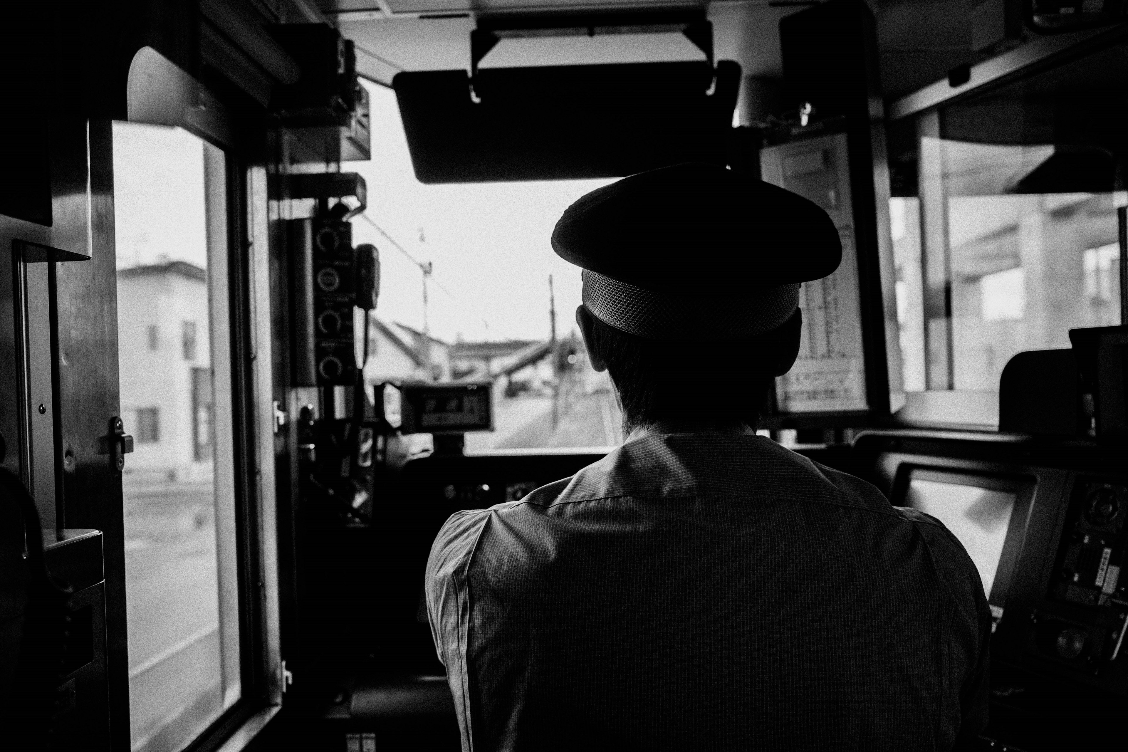 Black and white image of a train driver in the cockpit