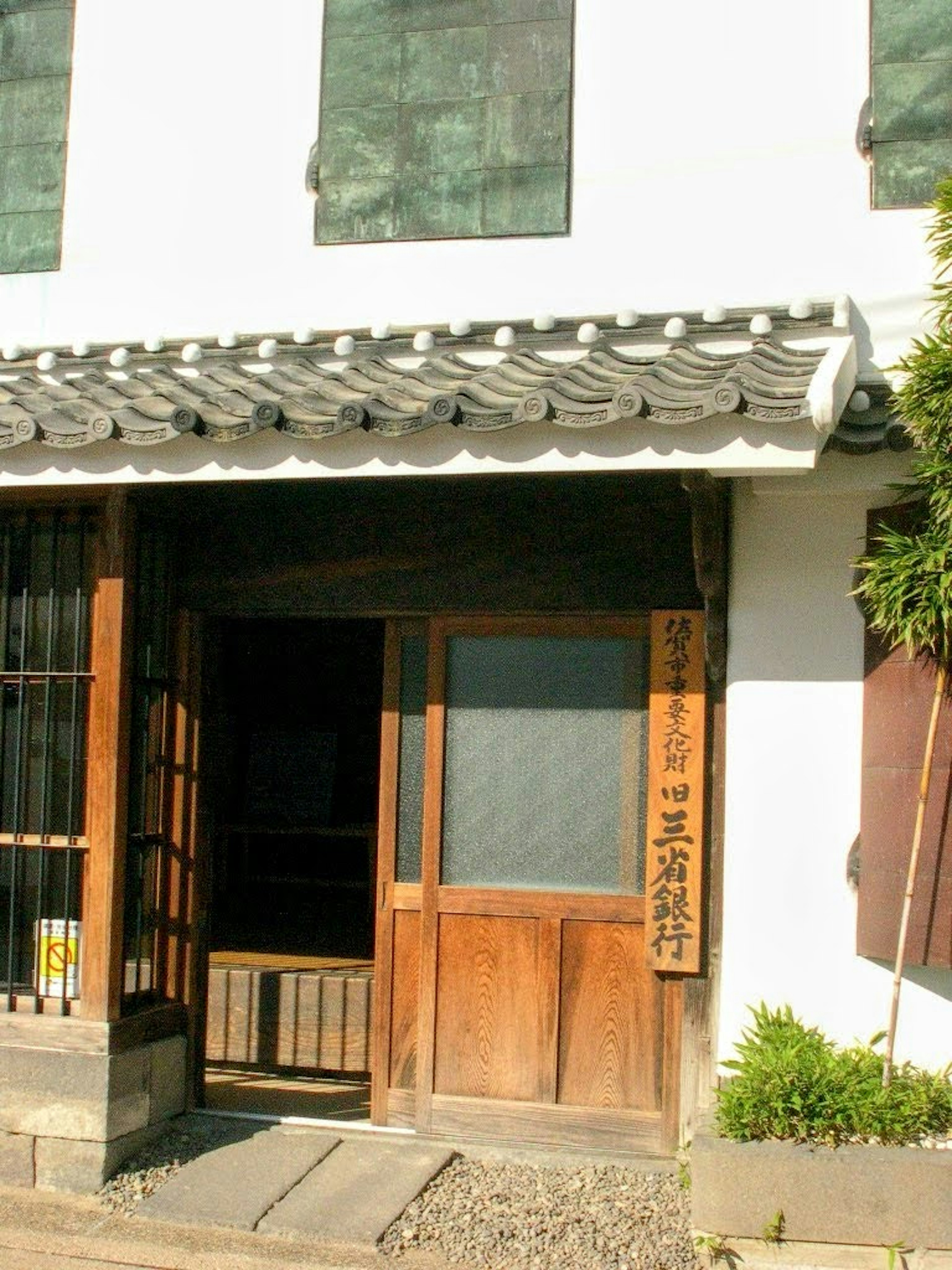 Traditional Japanese building entrance with wooden door and tiled roof