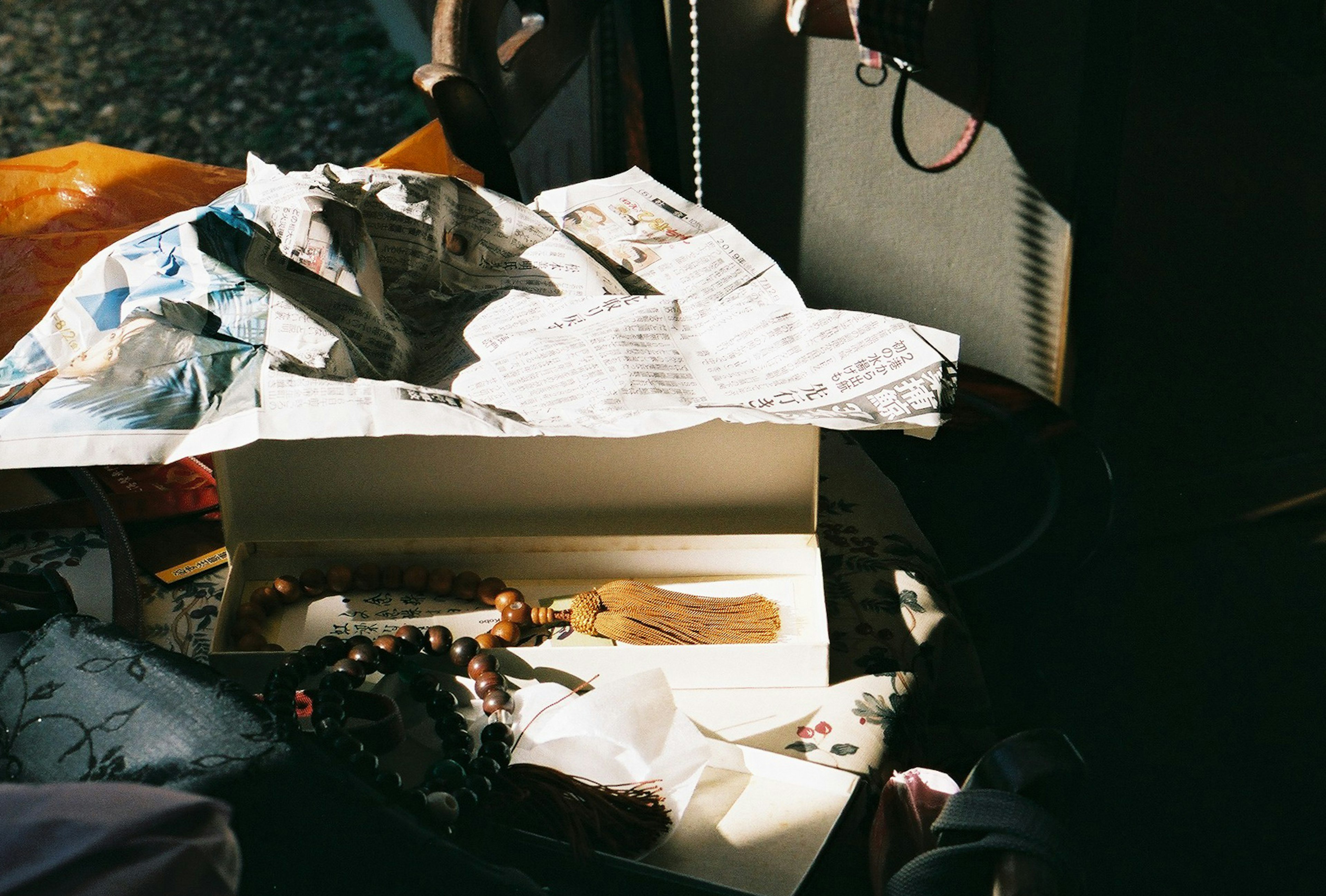 A cluttered scene on a table with newspapers and various small items