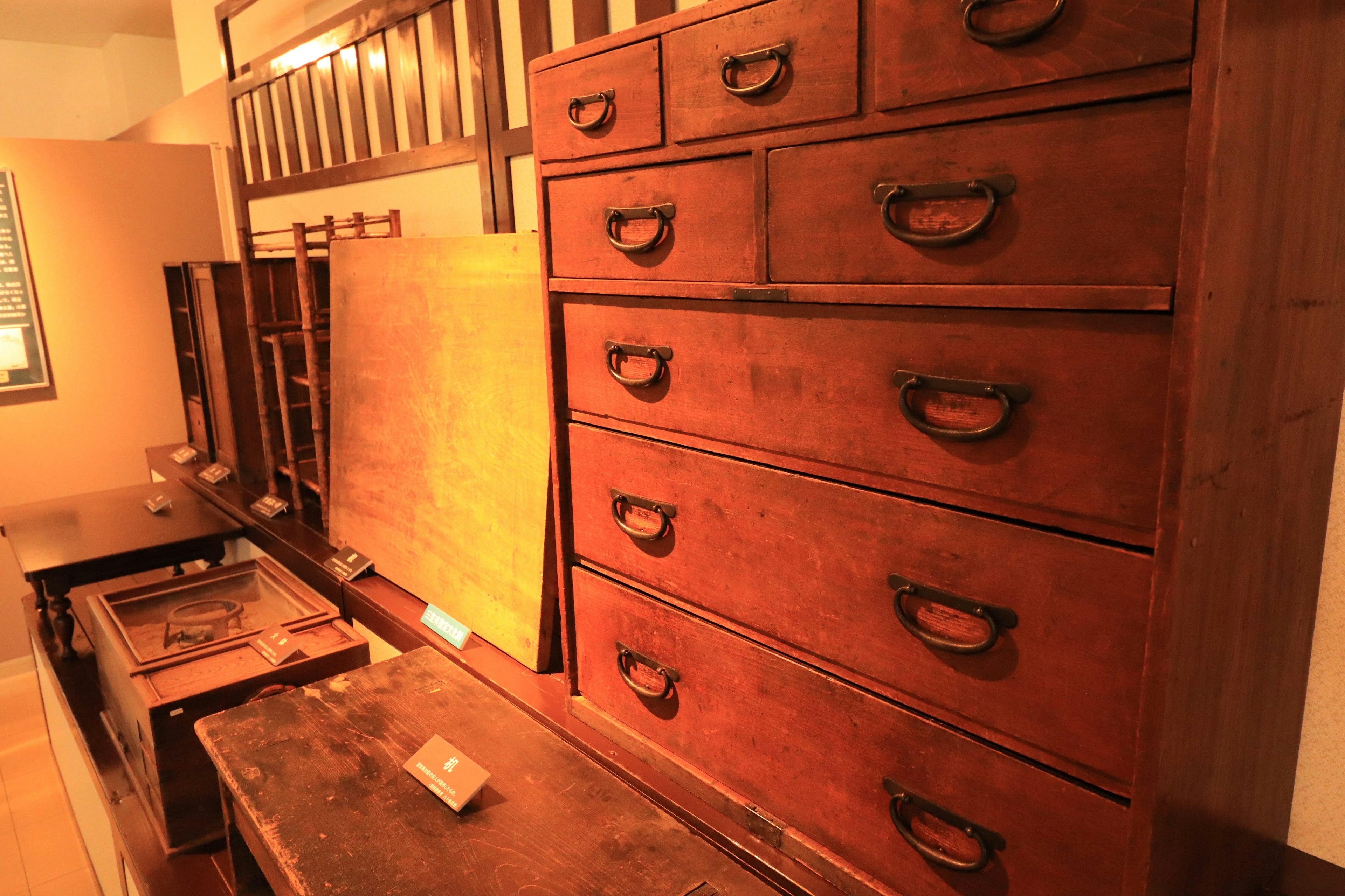 Interior view of a room with wooden furniture featuring multiple drawers