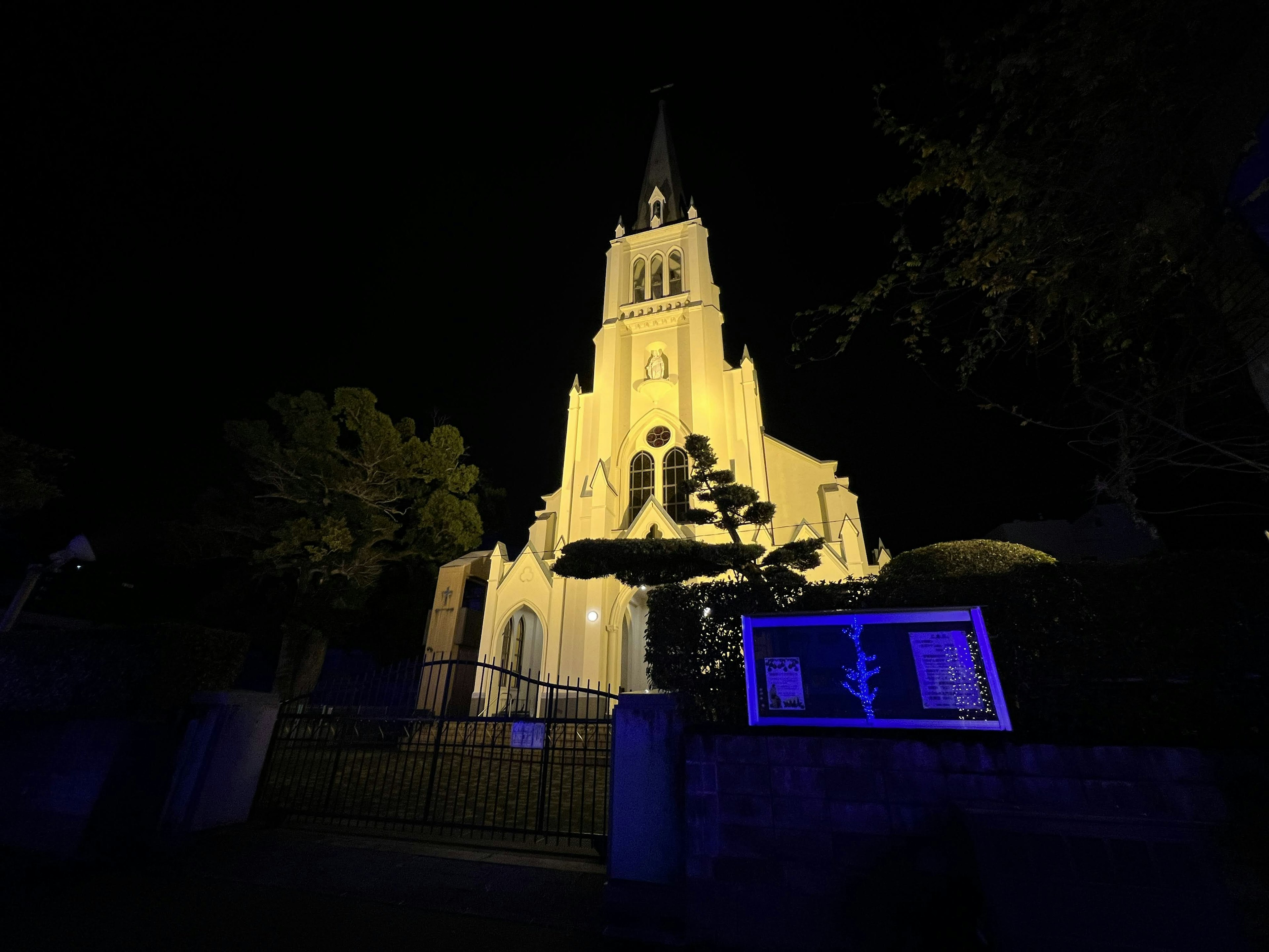 Fasad gereja yang indah diterangi di malam hari dengan cahaya biru