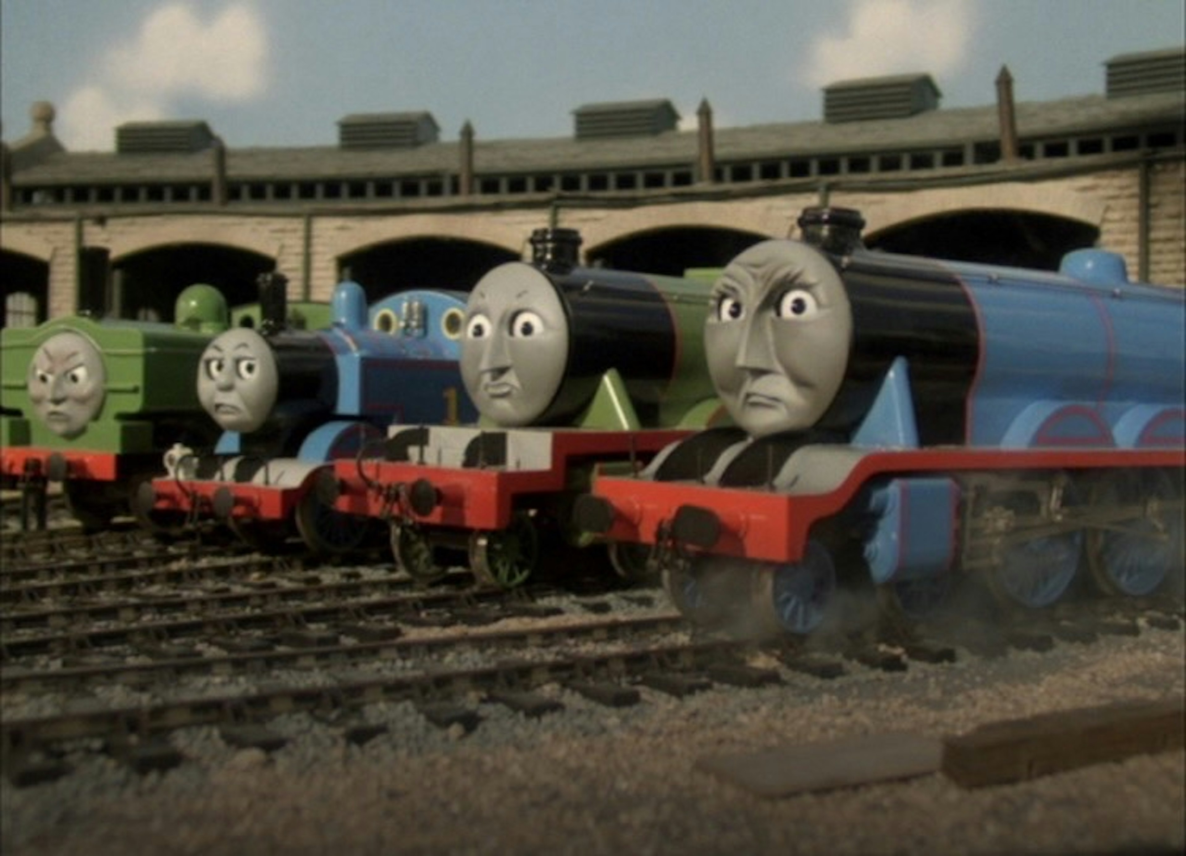 Characters from Thomas the Tank Engine lined up on the tracks