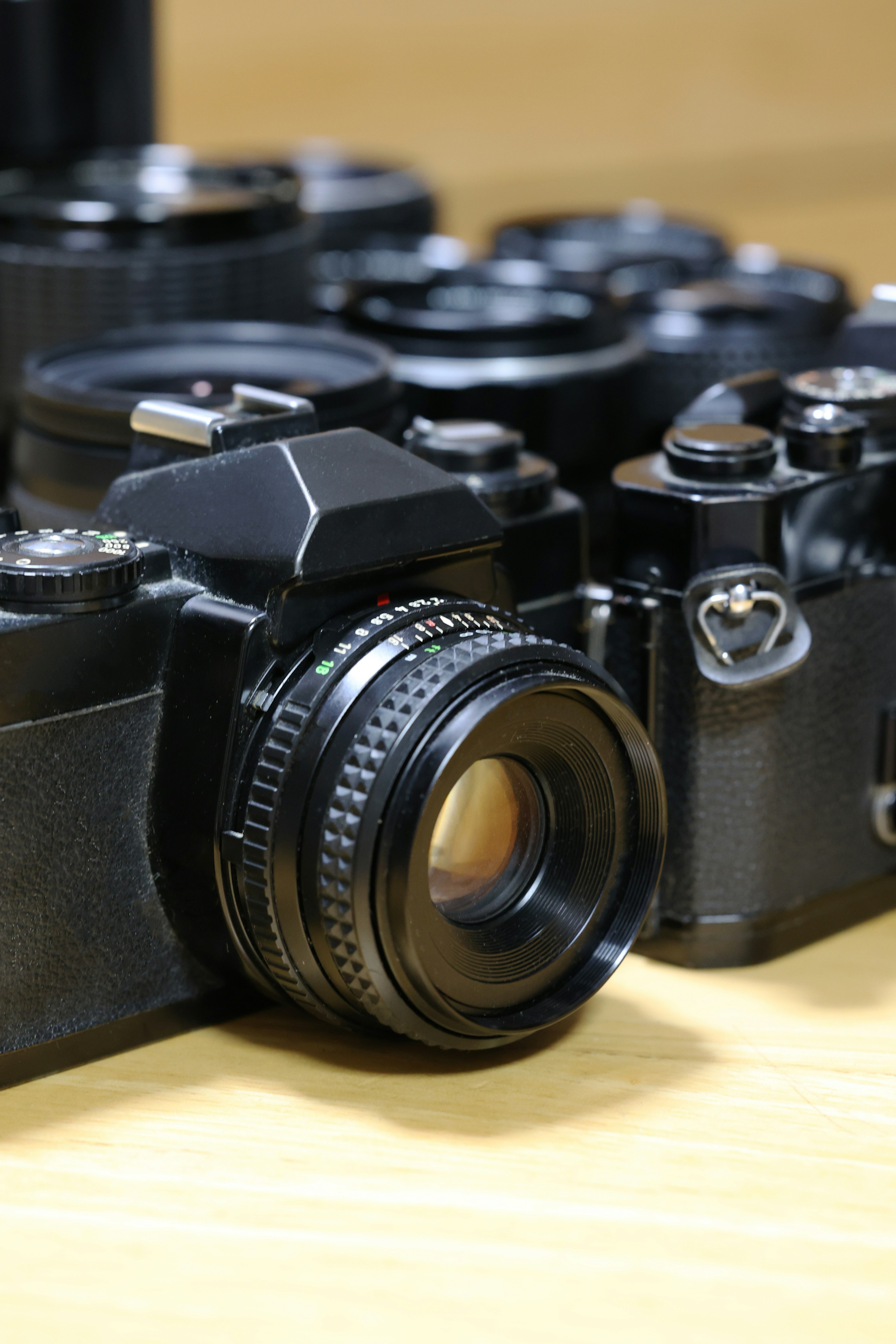 Image featuring black cameras and lenses arranged together