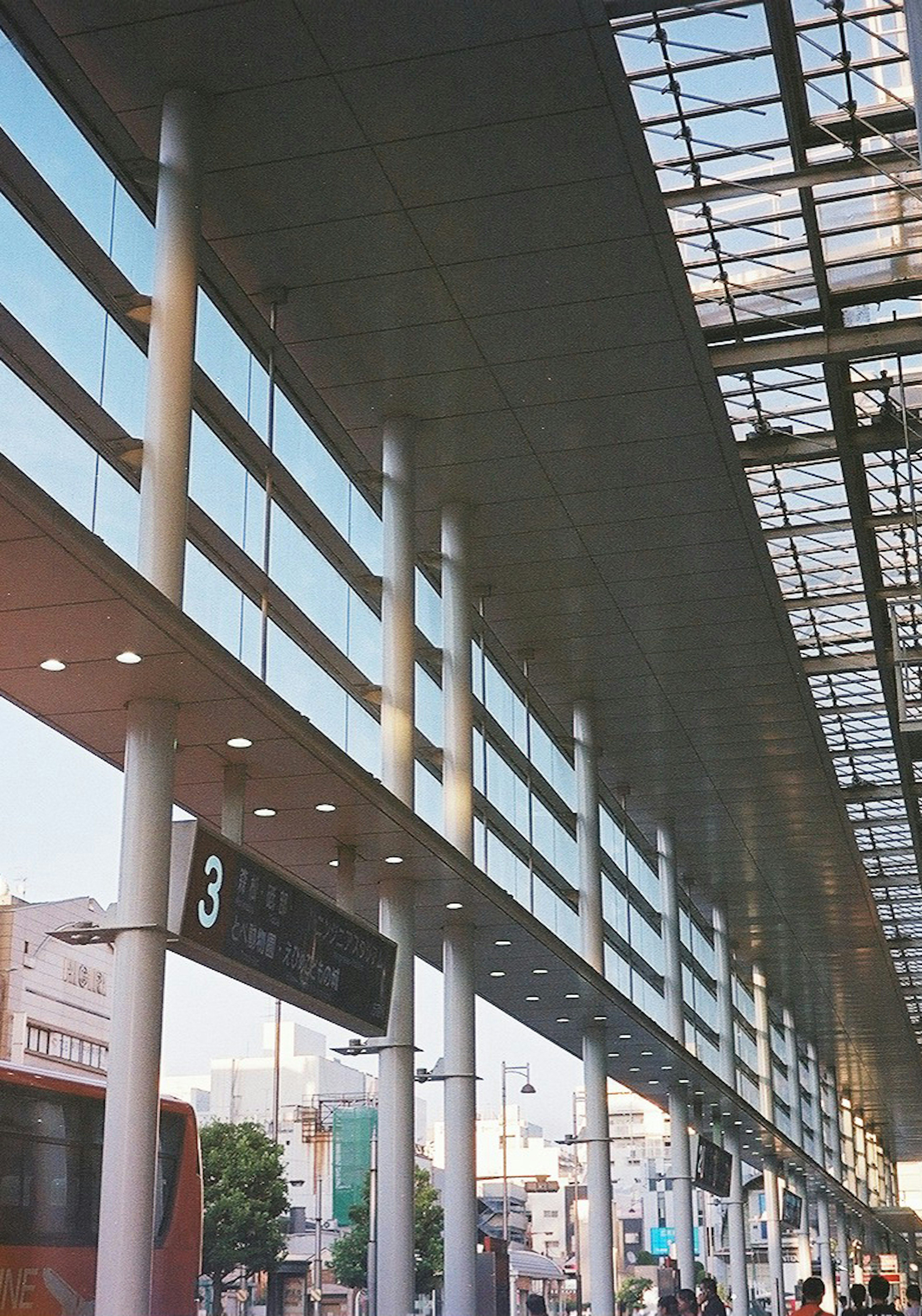 Bright indoor bus station scene featuring platform number three