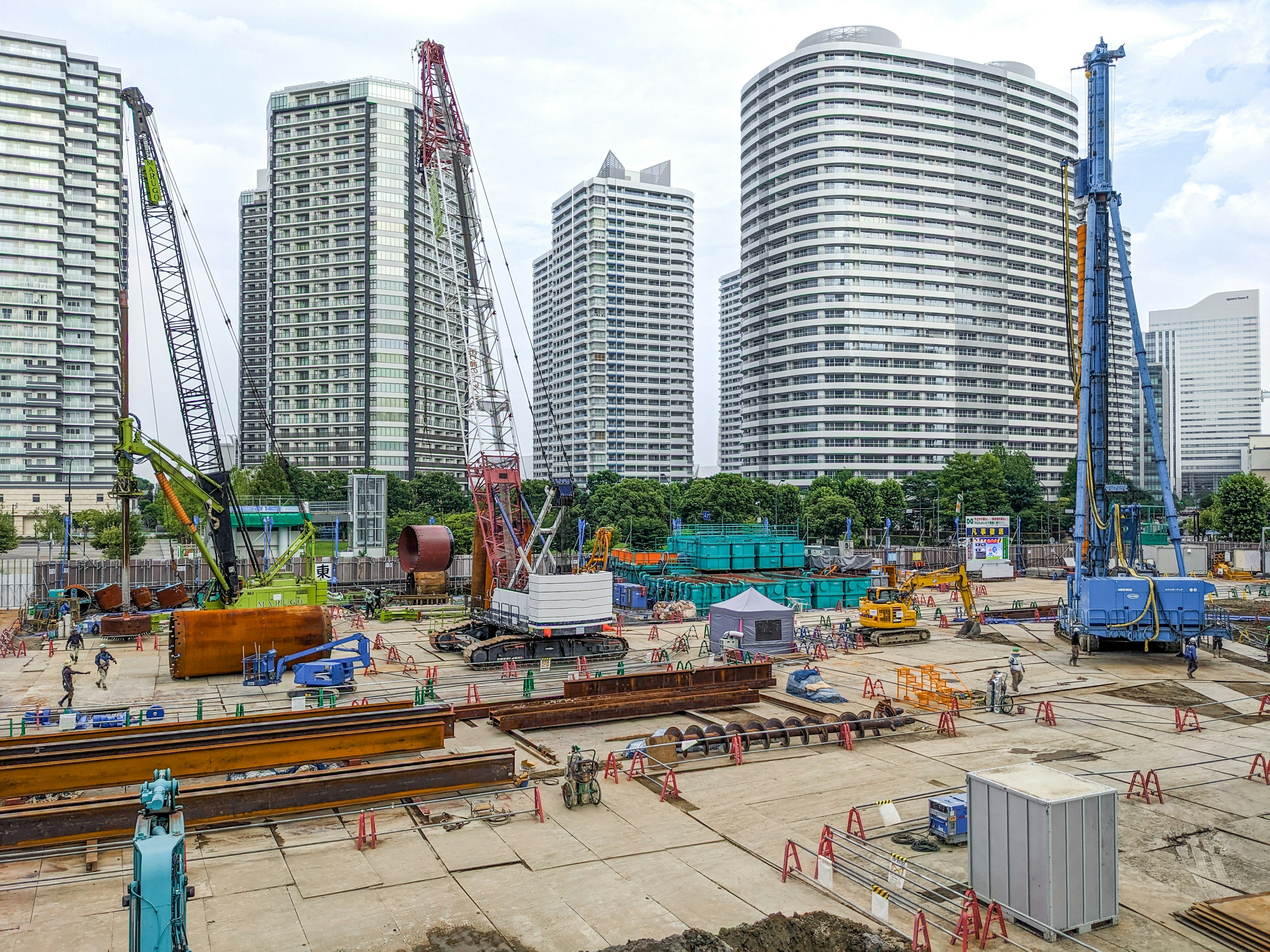 Construction site with high-rise buildings cranes and machinery in operation