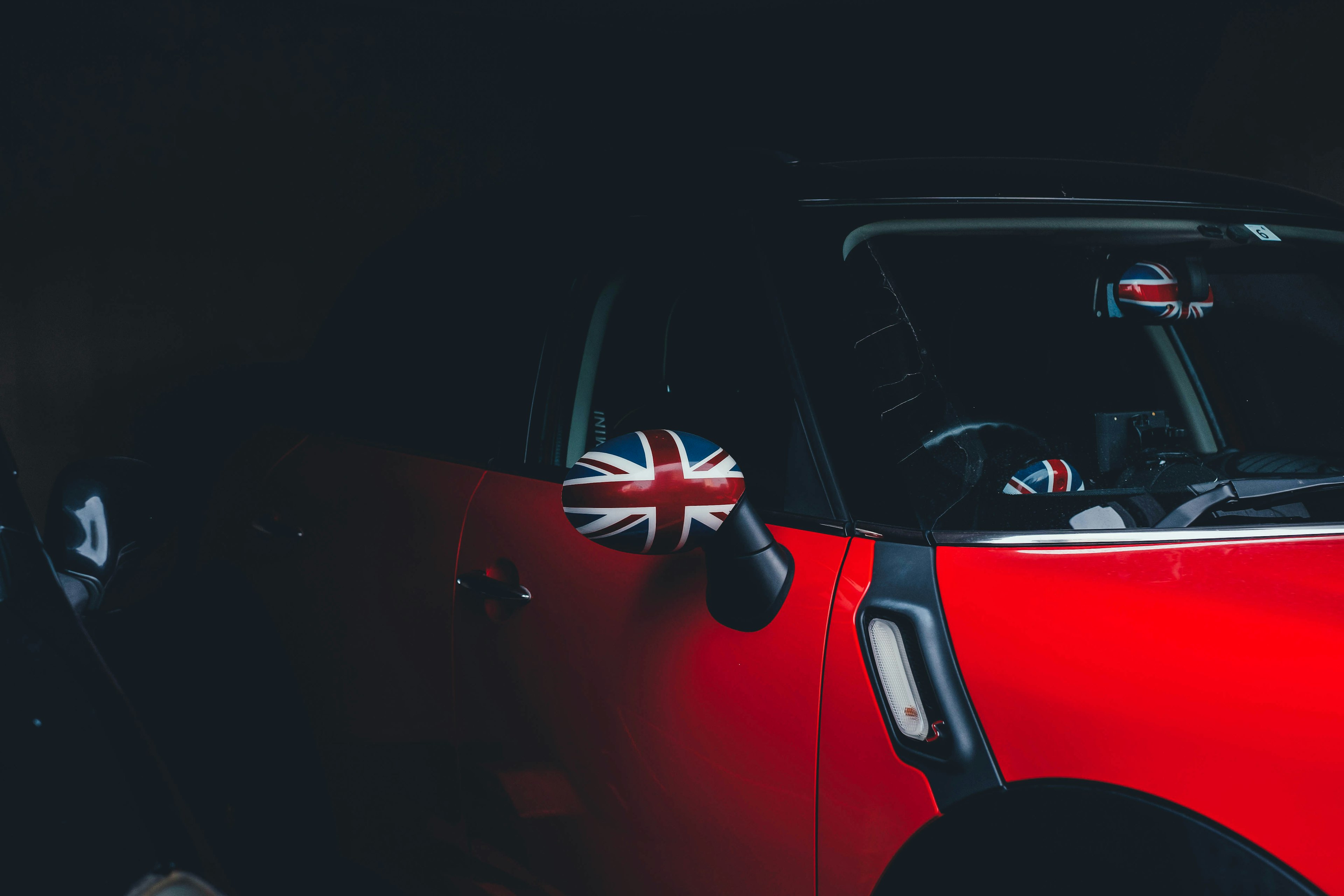 Red car featuring British flag side mirror