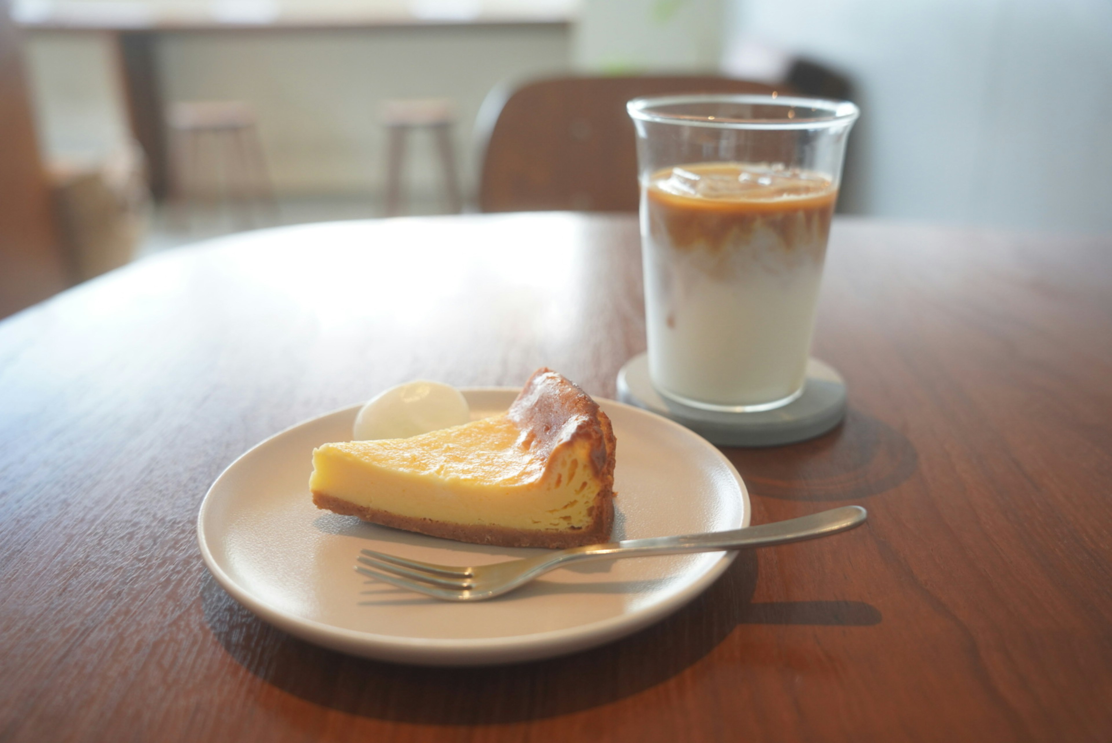 Cafe table with cheesecake and iced coffee