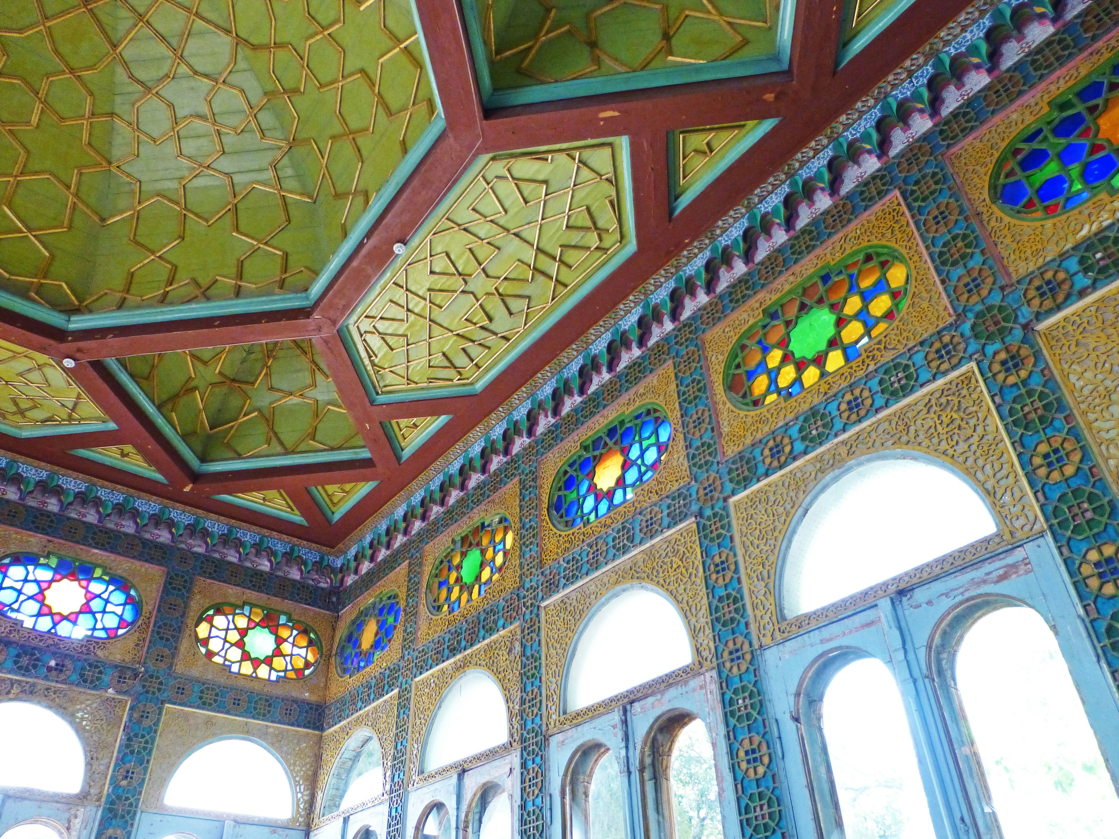 Decorative ceiling and walls featuring colorful mosaics and intricate designs