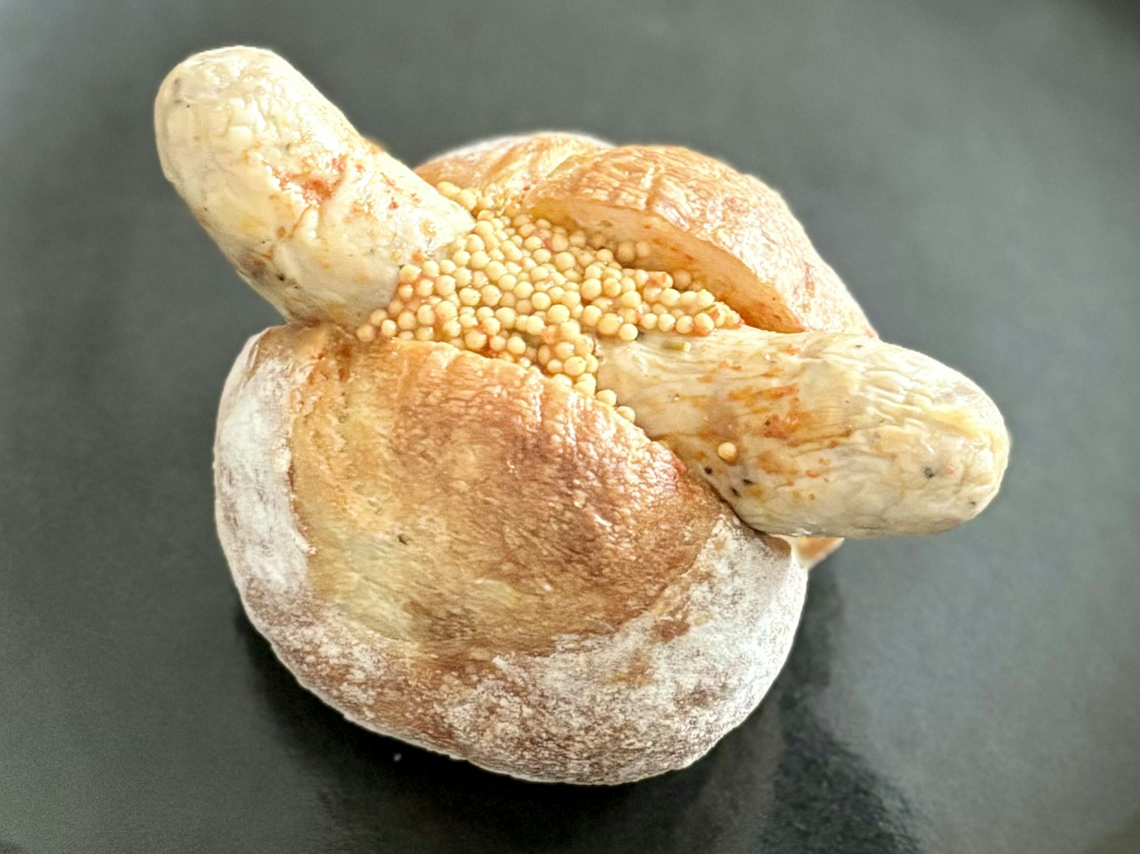 Unique shaped bread topped with mustard seeds