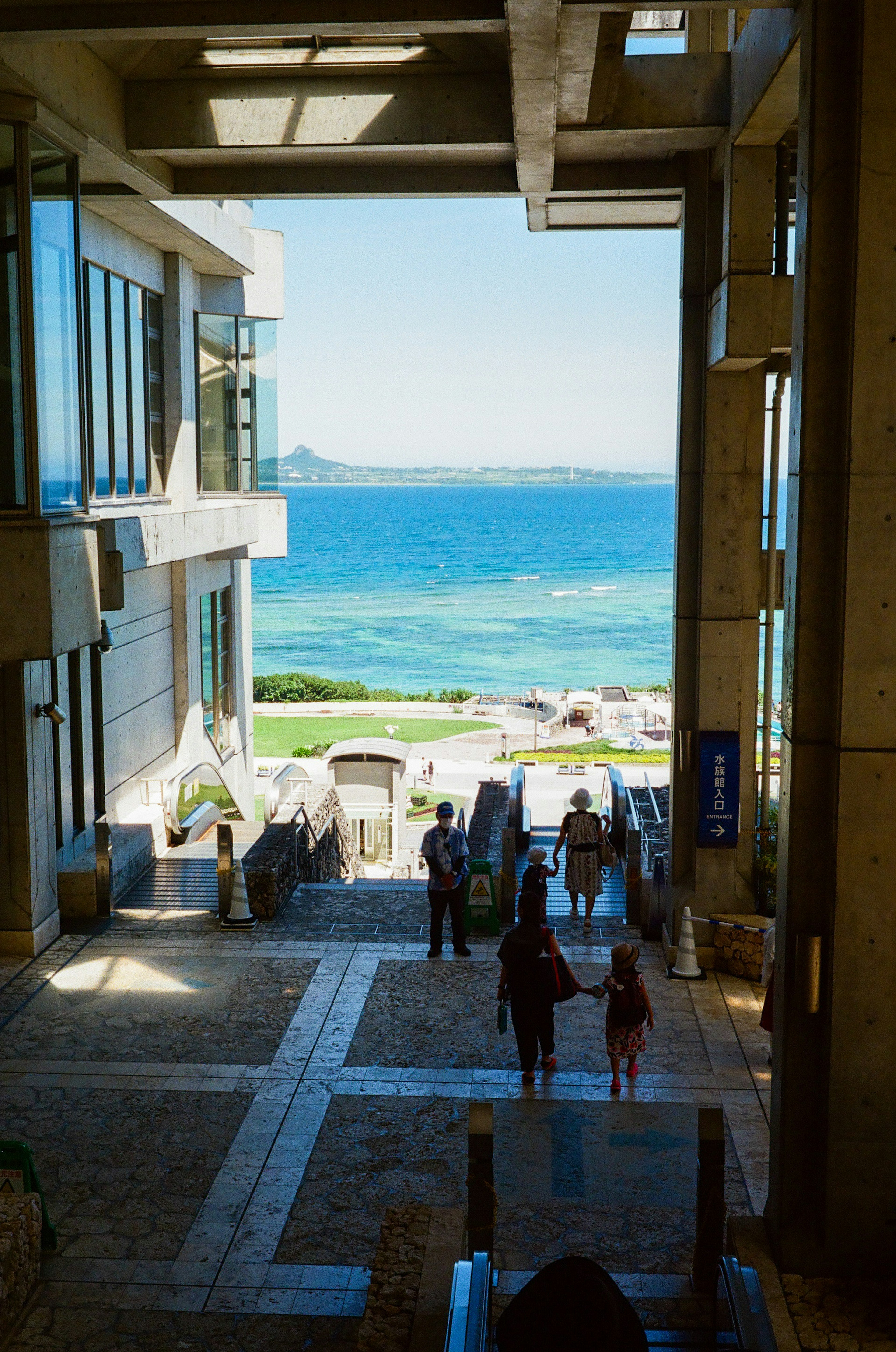 Modern building interior with ocean view and visitors