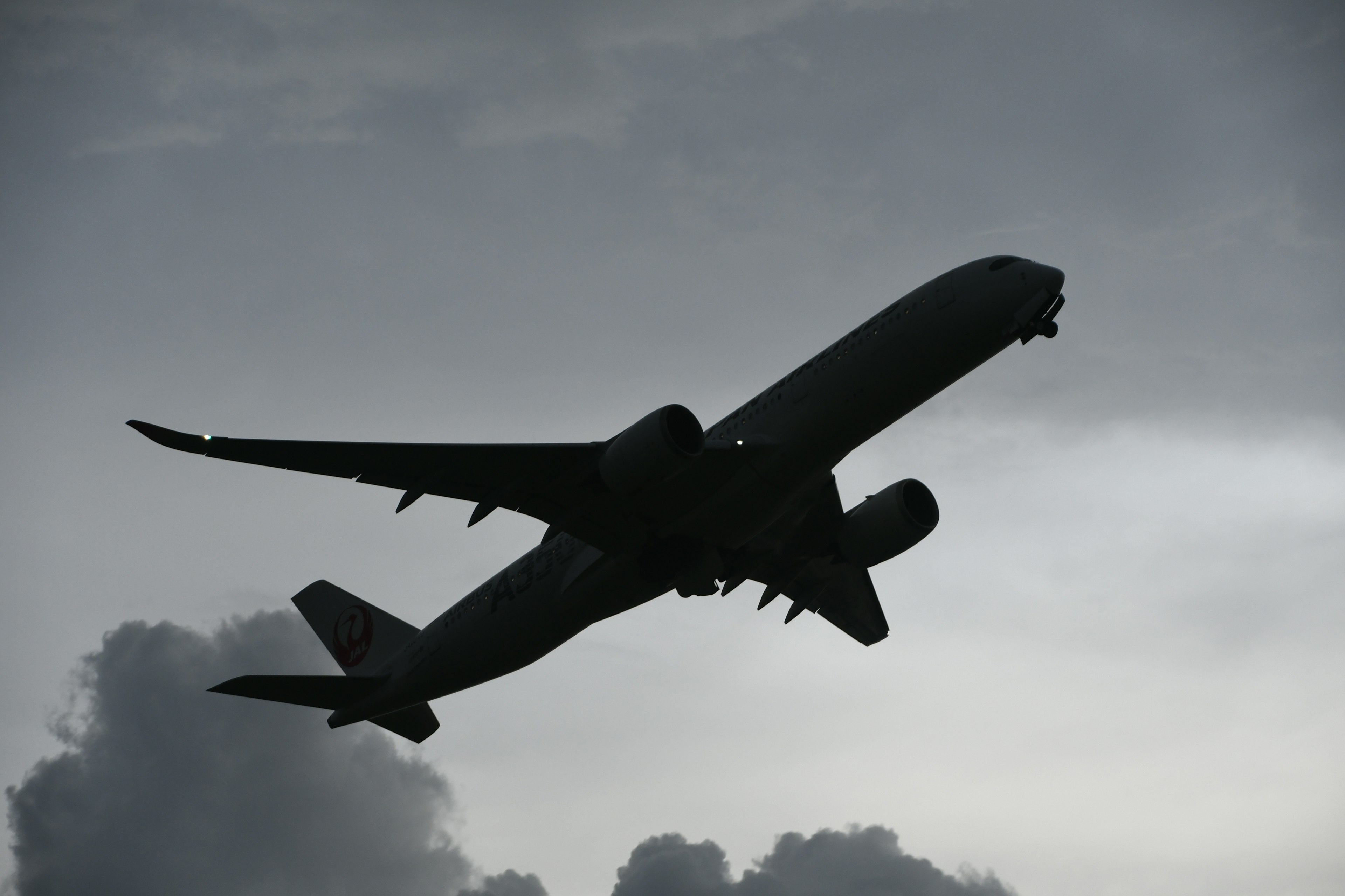 Silhouette di un aereo che vola tra le nuvole