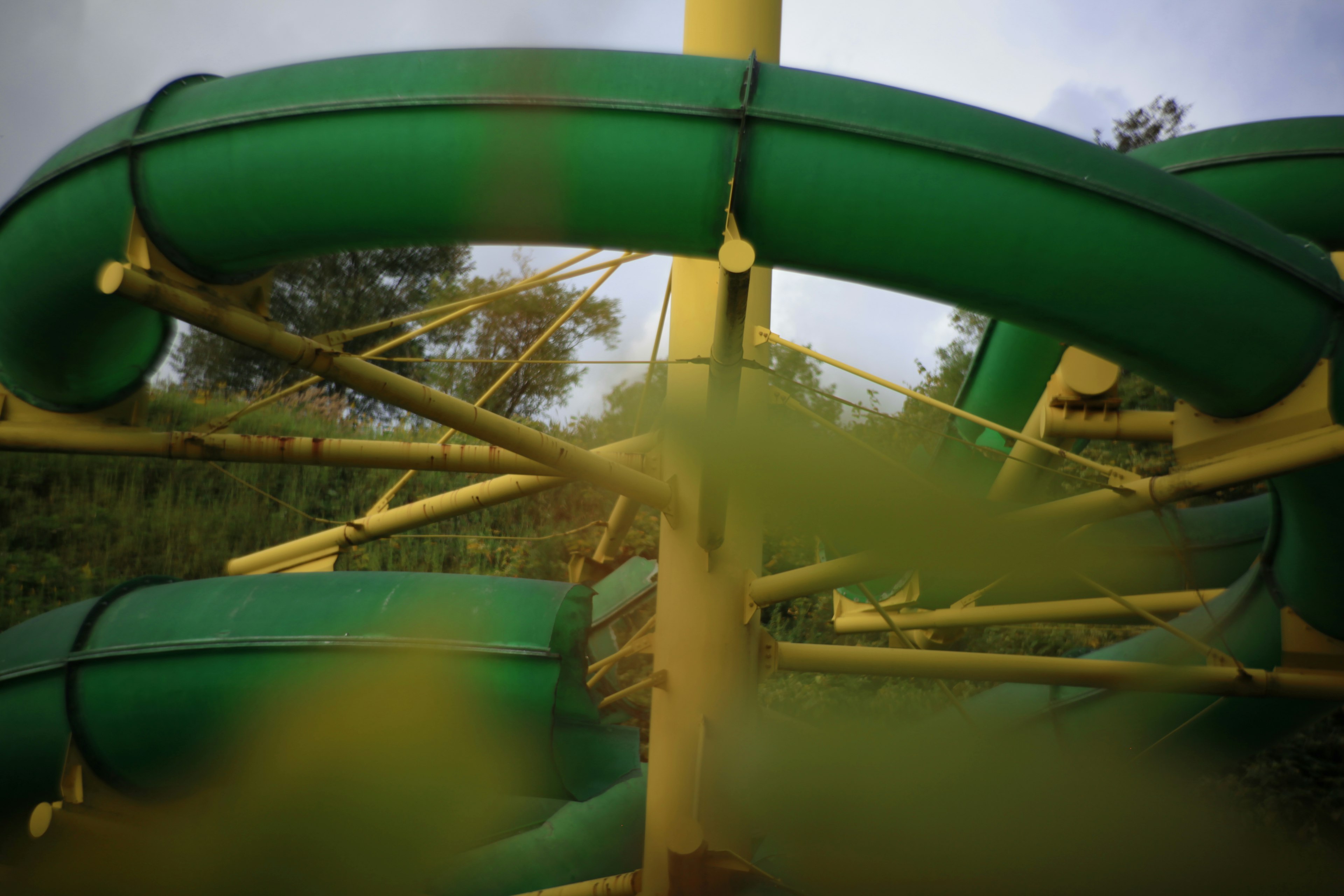 Playground structure featuring green water slides