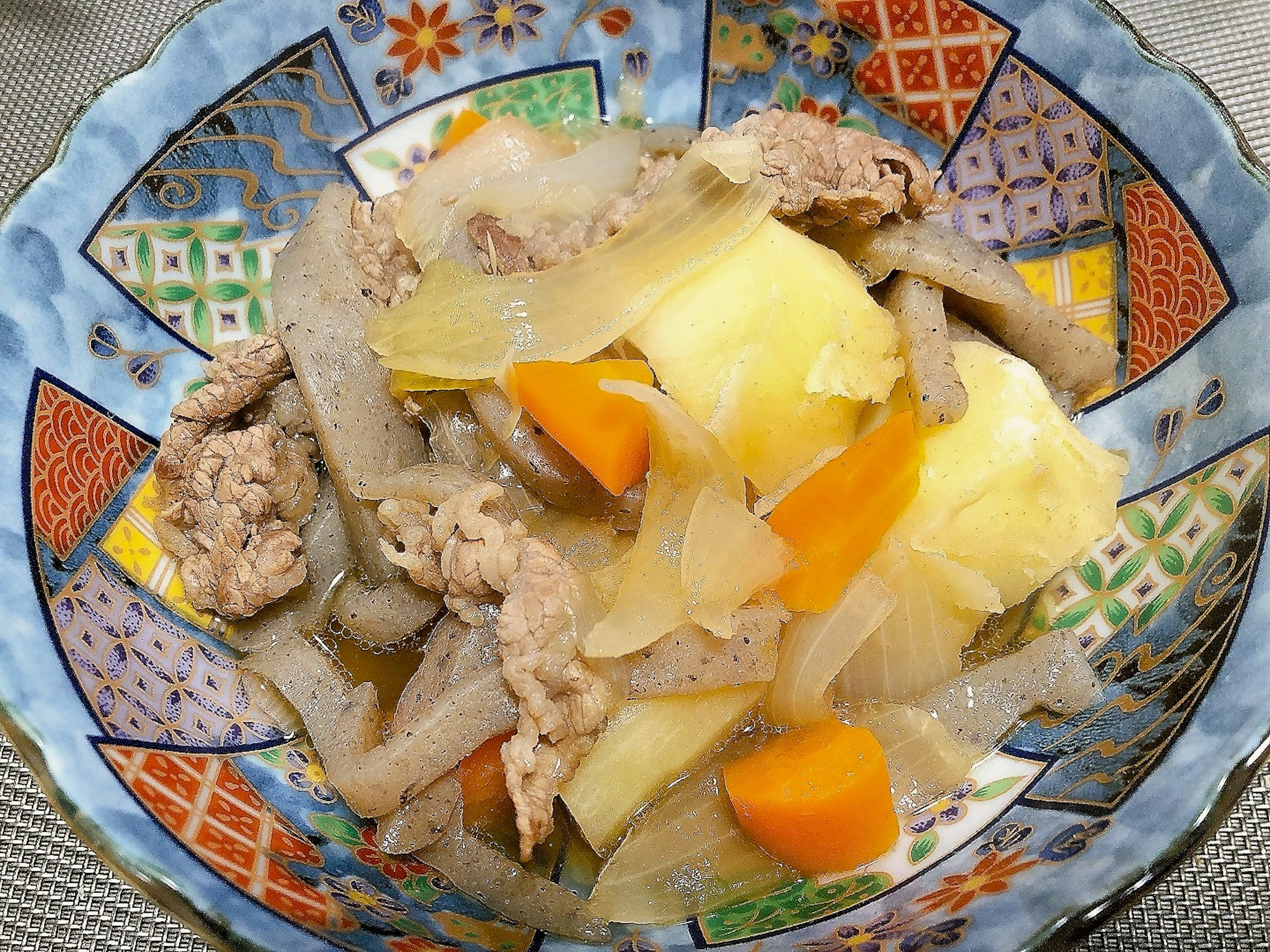 Hearty stew served in a beautifully patterned bowl