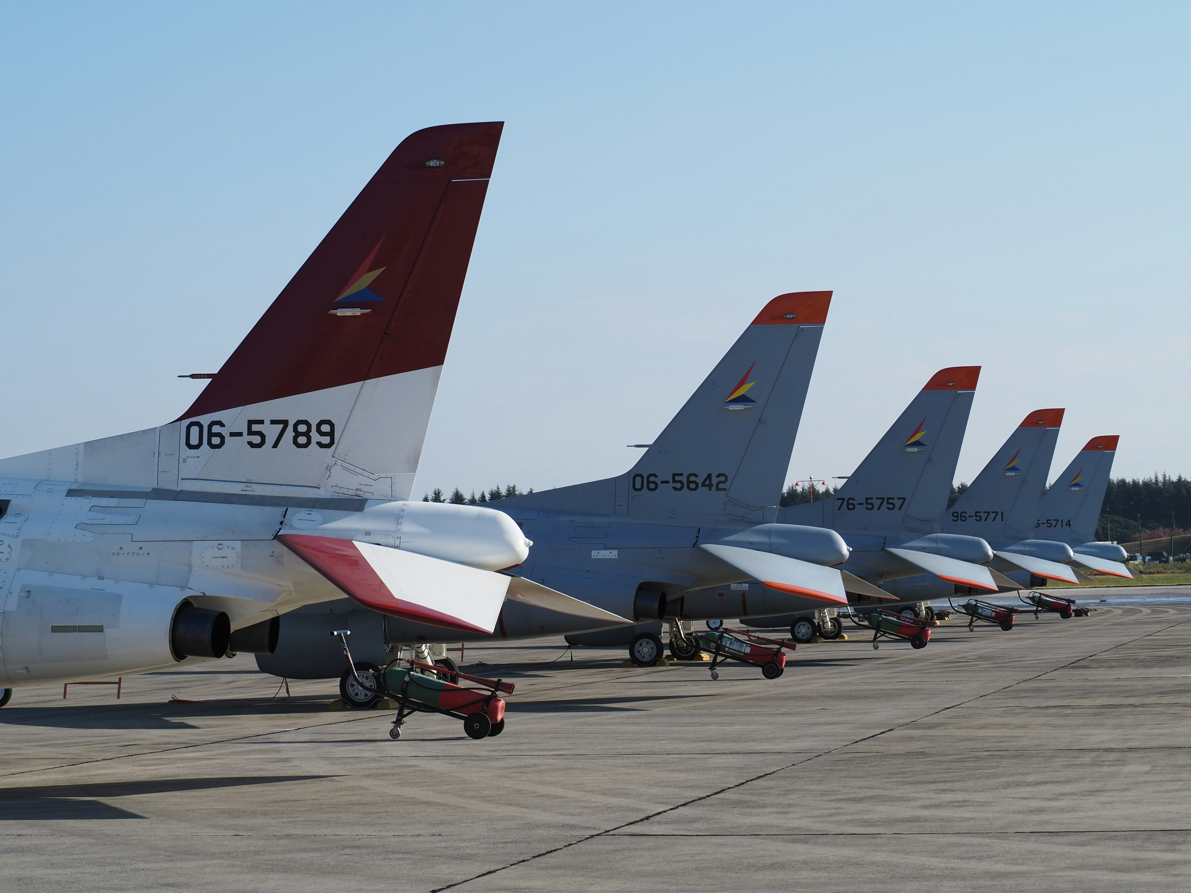 Multiple aircraft tails lined up on a runway