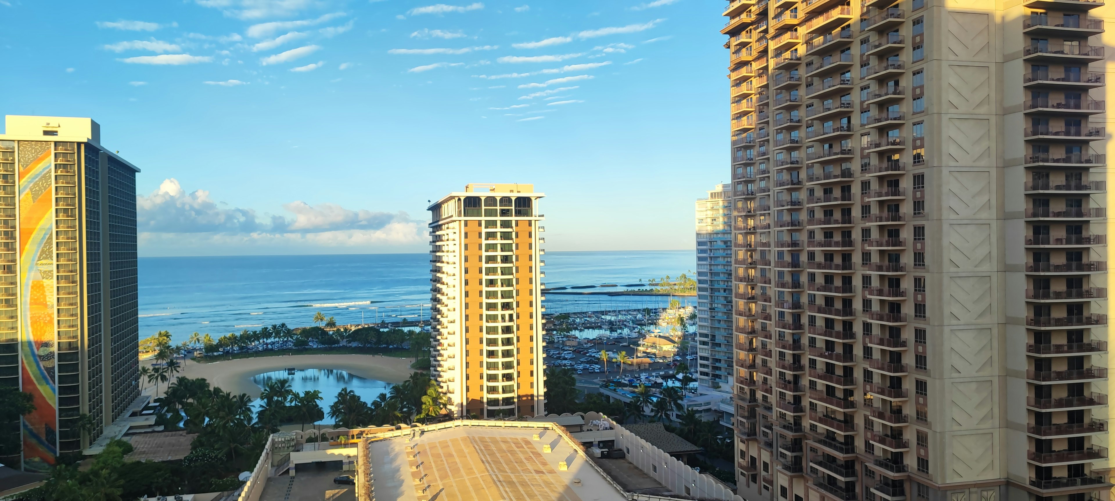 A scenic view featuring high-rise buildings and the ocean