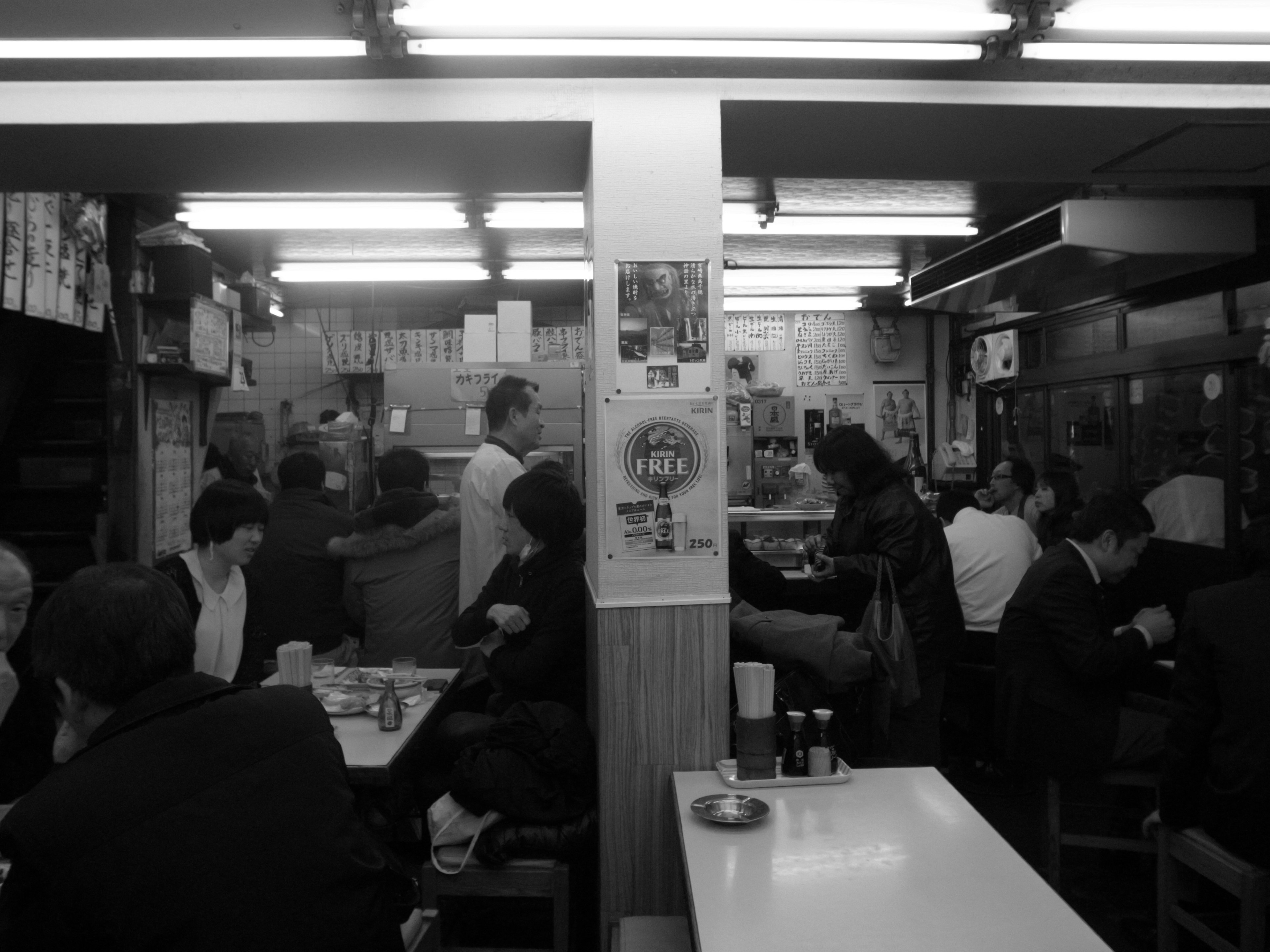 Black and white image of people dining in a restaurant