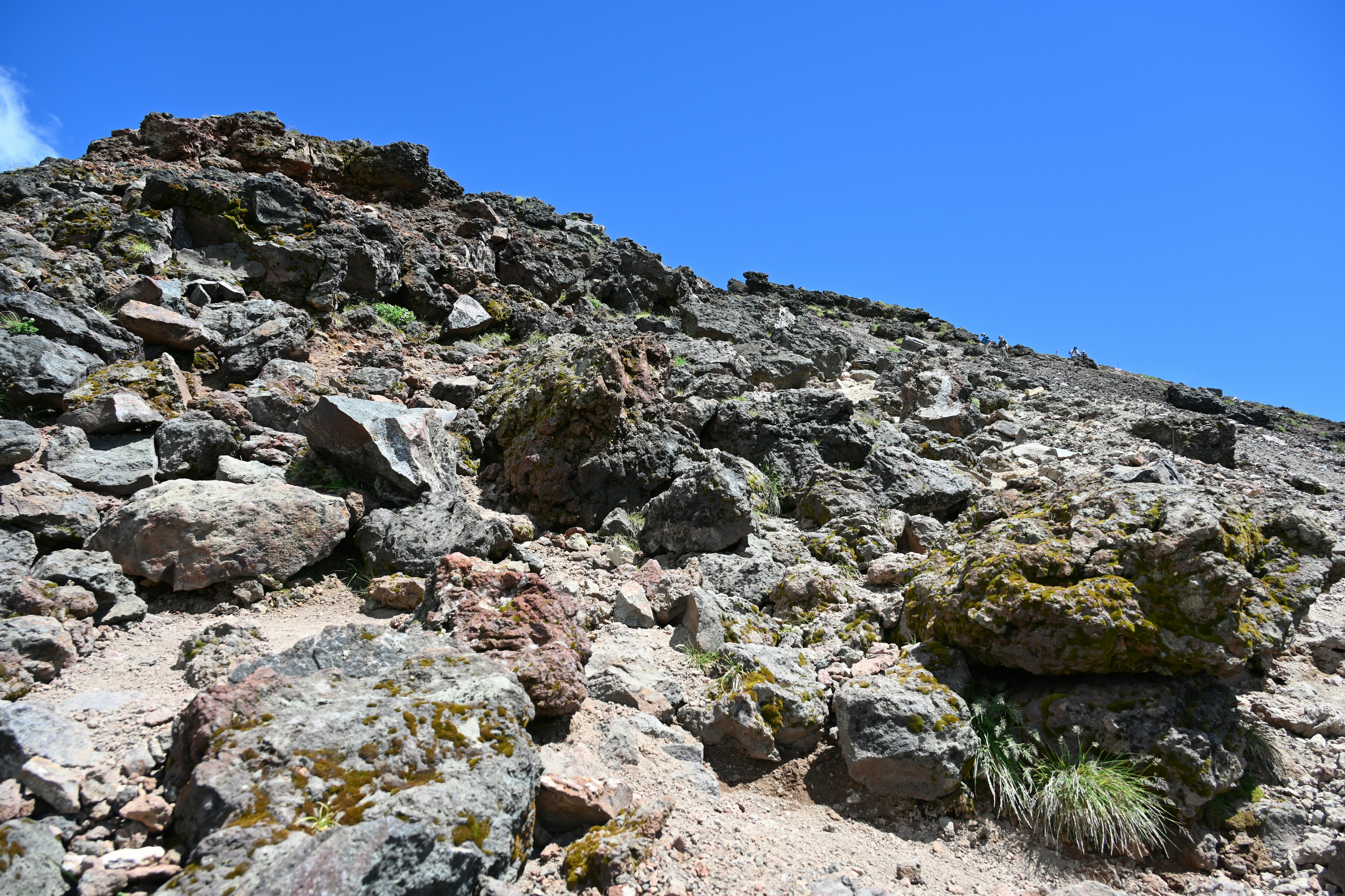 Photo d'une colline rocheuse avec des touffes d'herbe