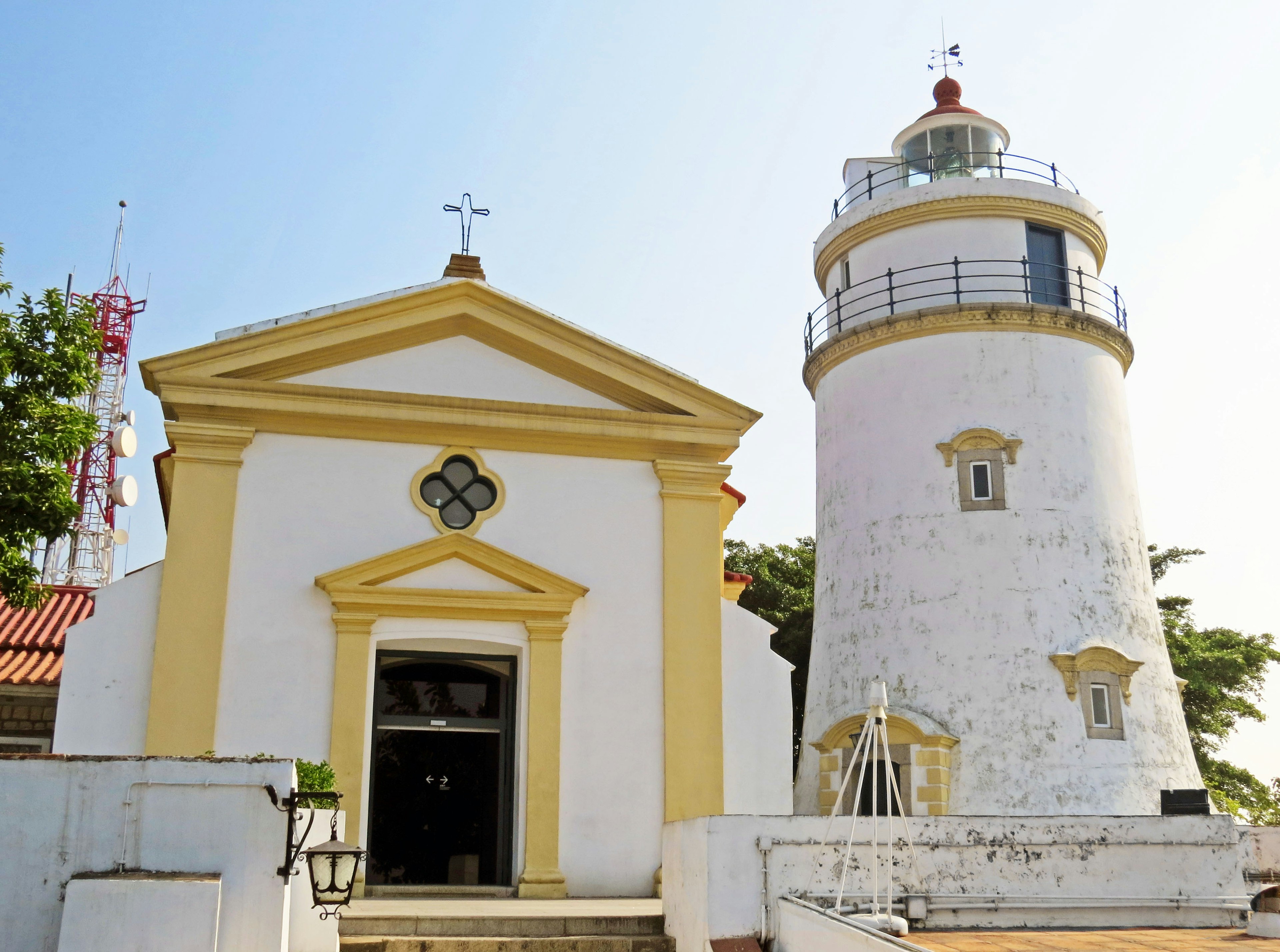 A scenic view featuring a lighthouse and church