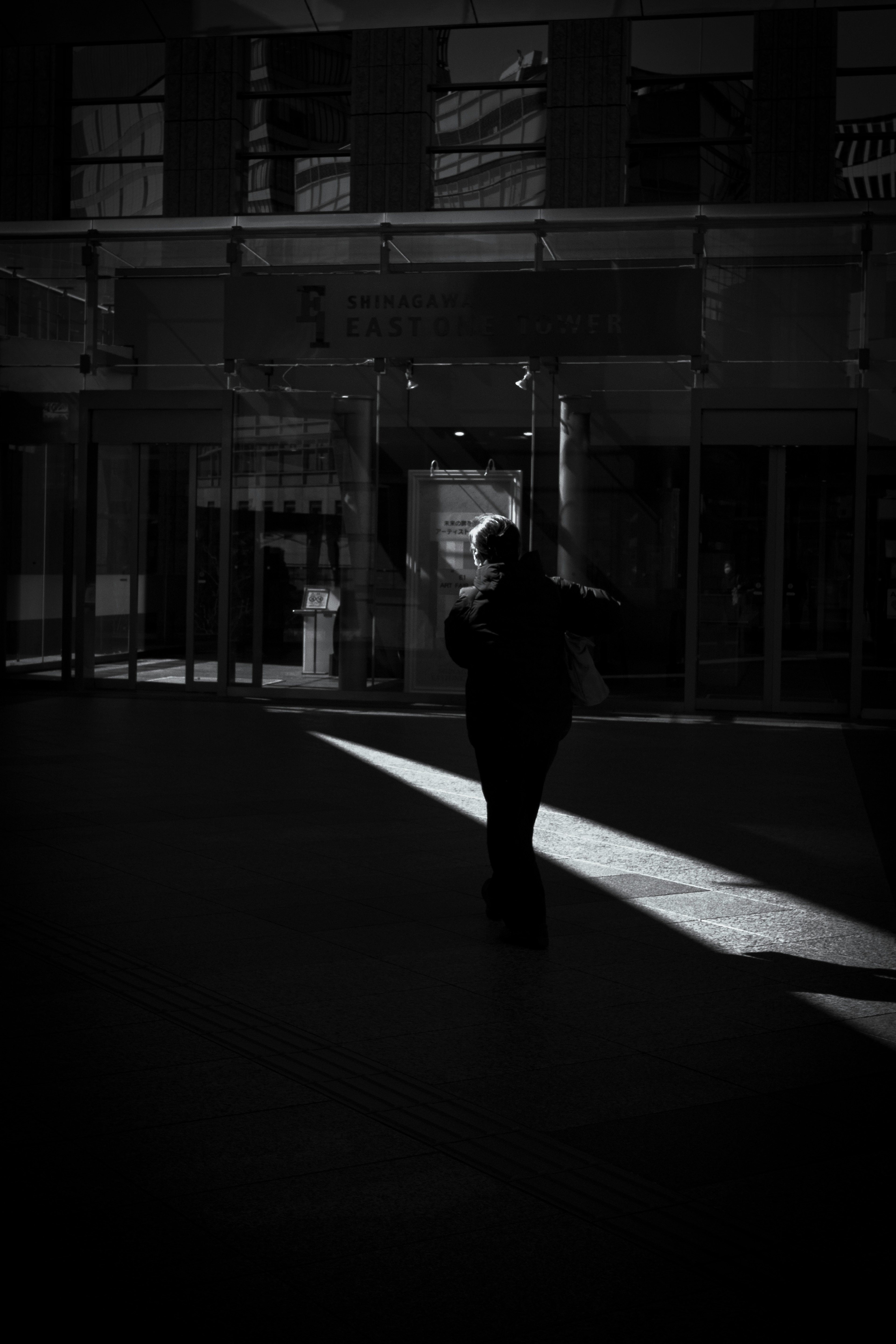 Silhouette of a person walking in dim light