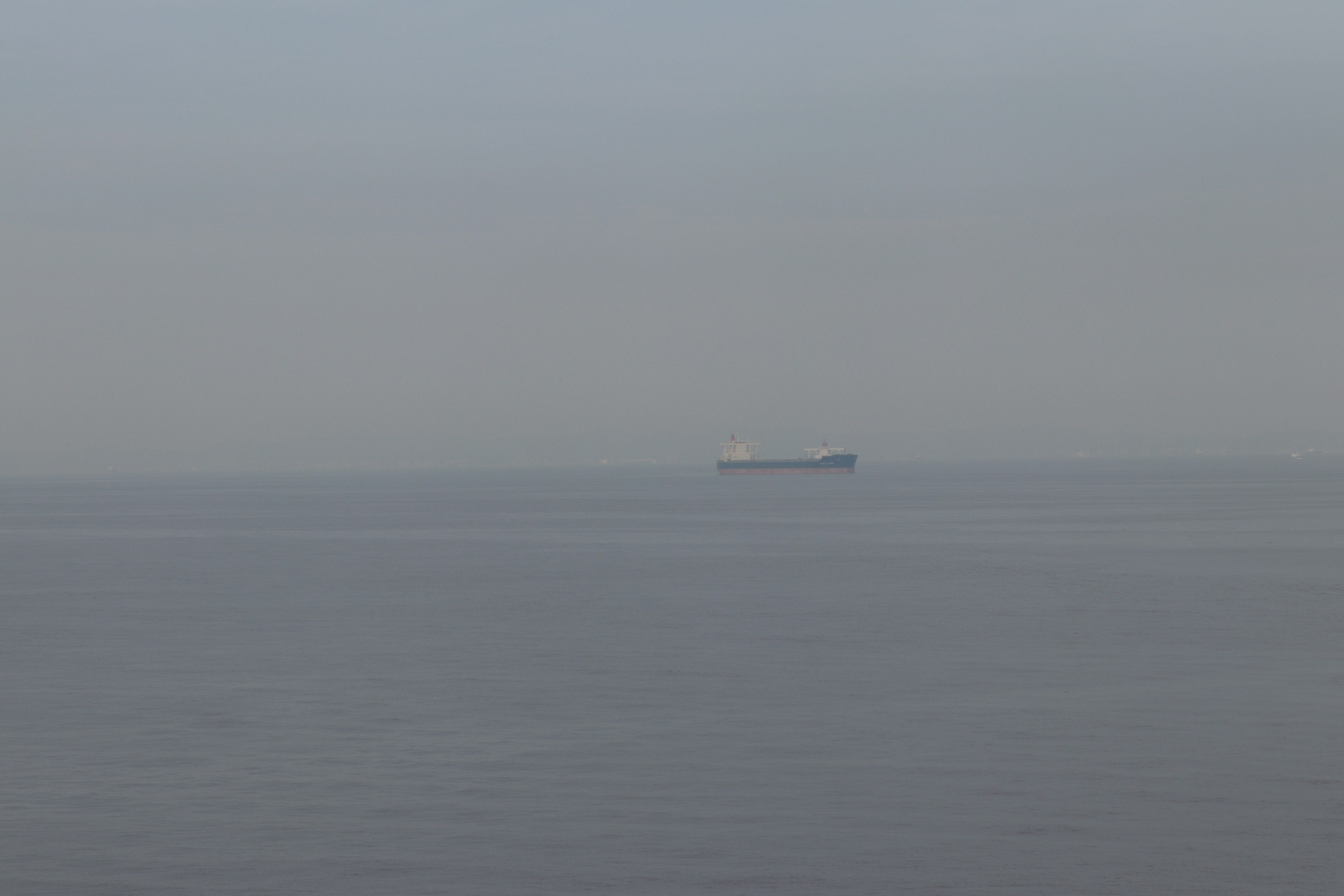 Distant ship floating on the sea