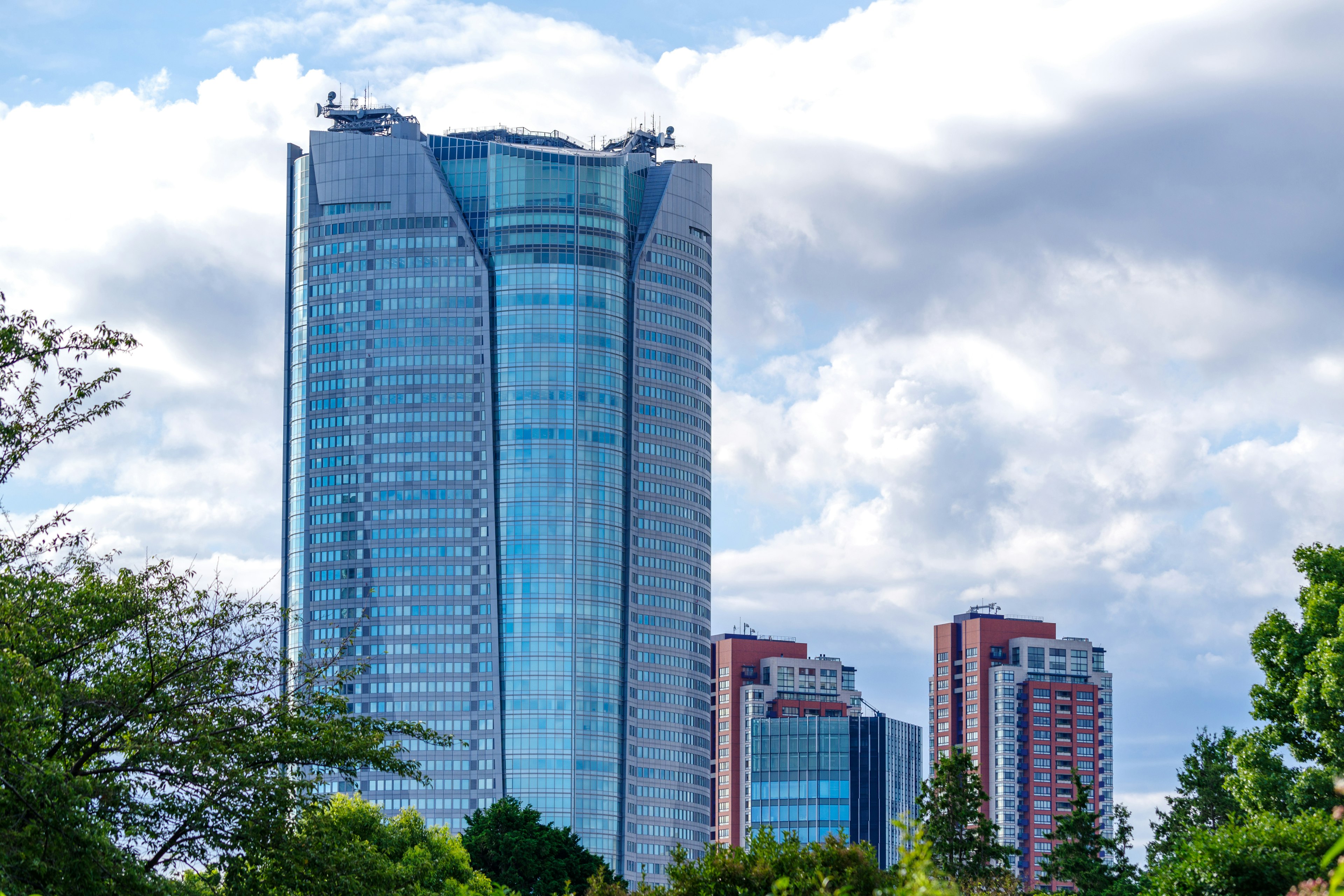 Skyline featuring a modern skyscraper with glass facade and surrounding buildings