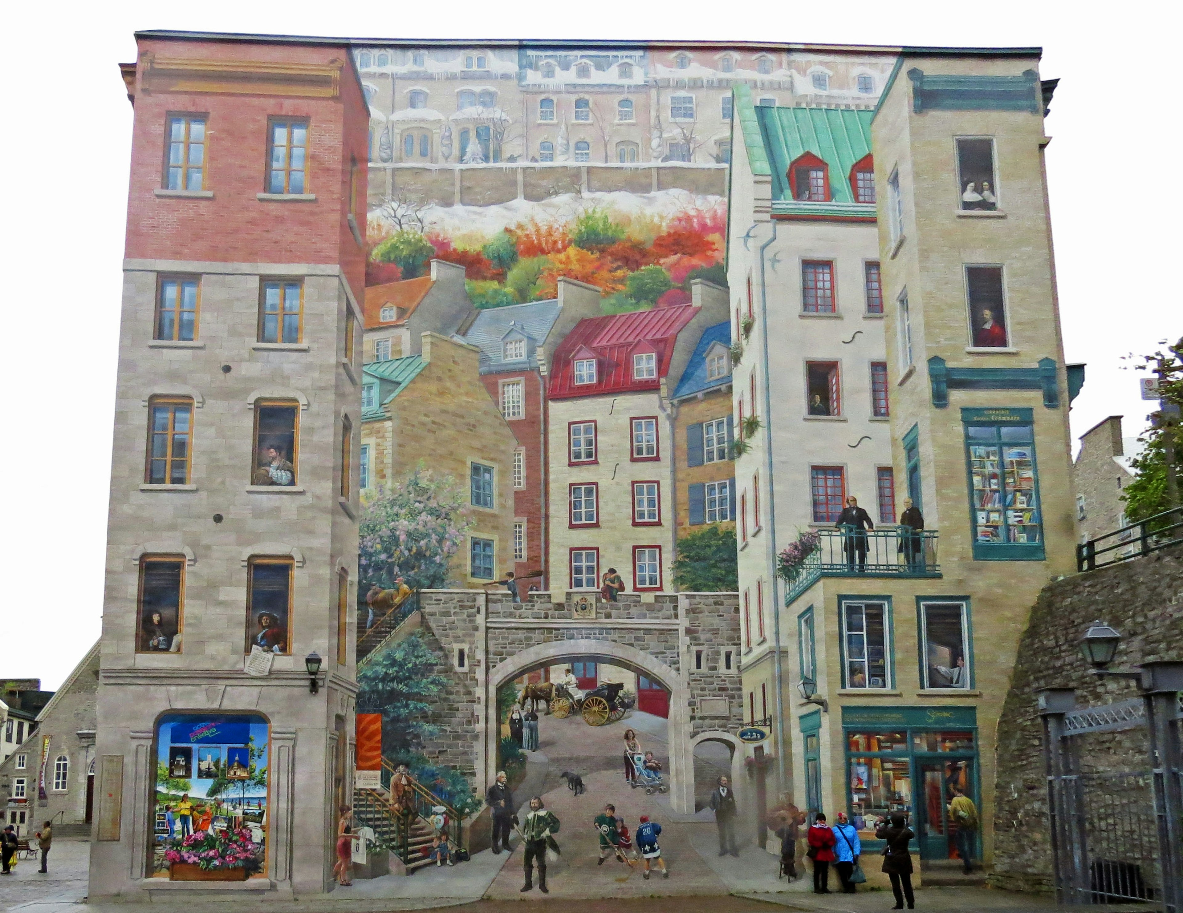 A vibrant mural on a building depicting a colorful cityscape with people