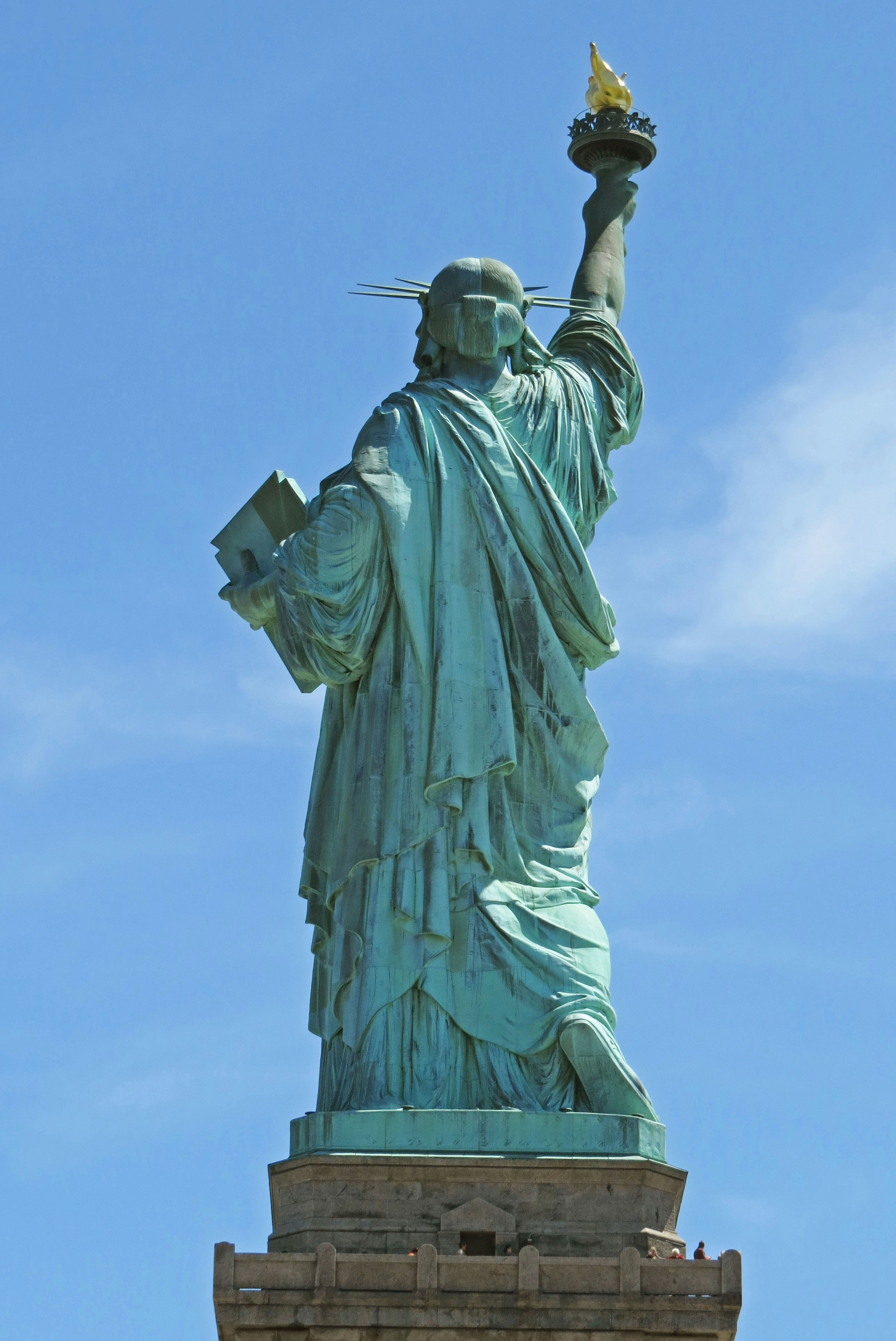 Statue of Liberty standing under a blue sky