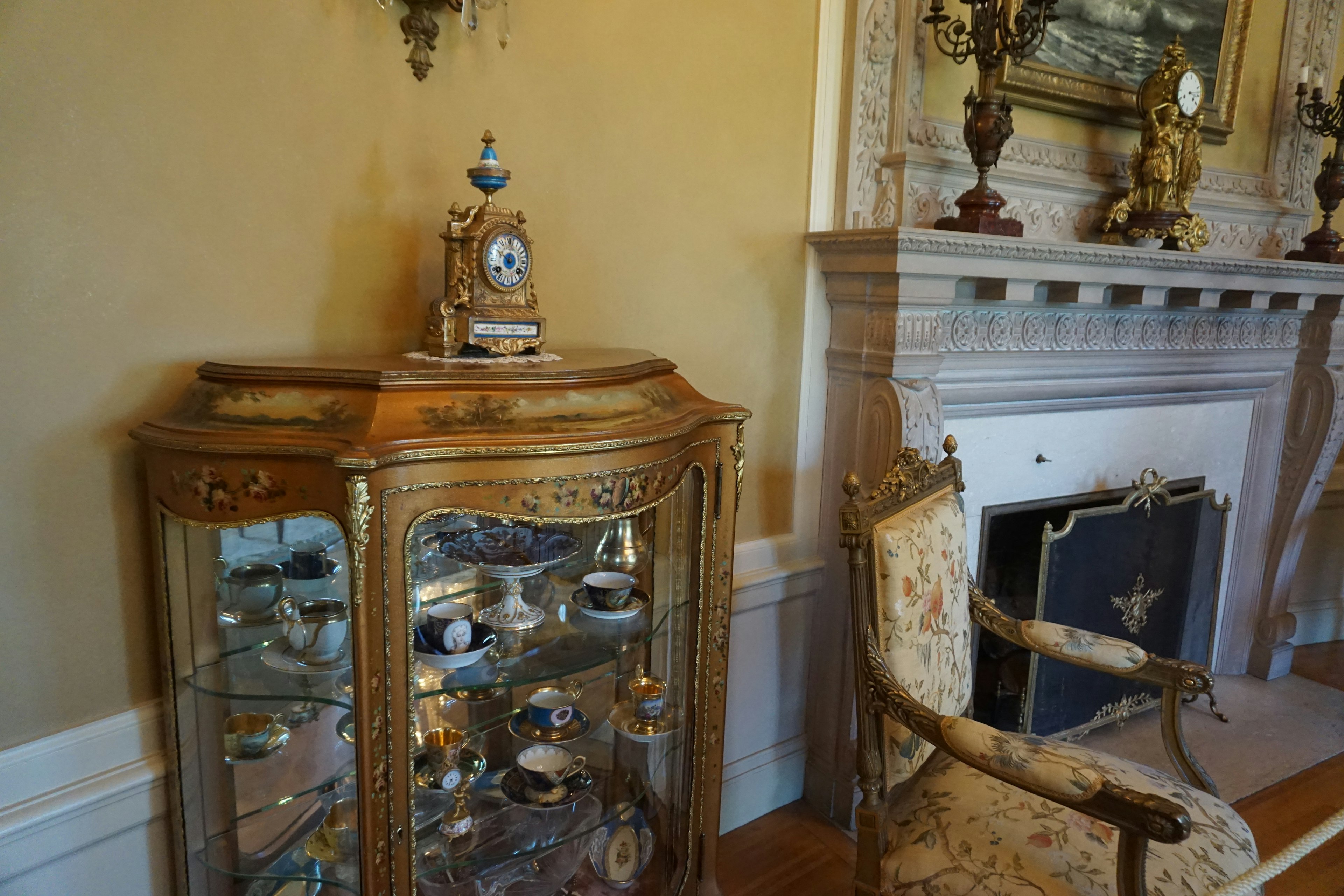 Salle avec un cabinet orné et une chaise ancienne