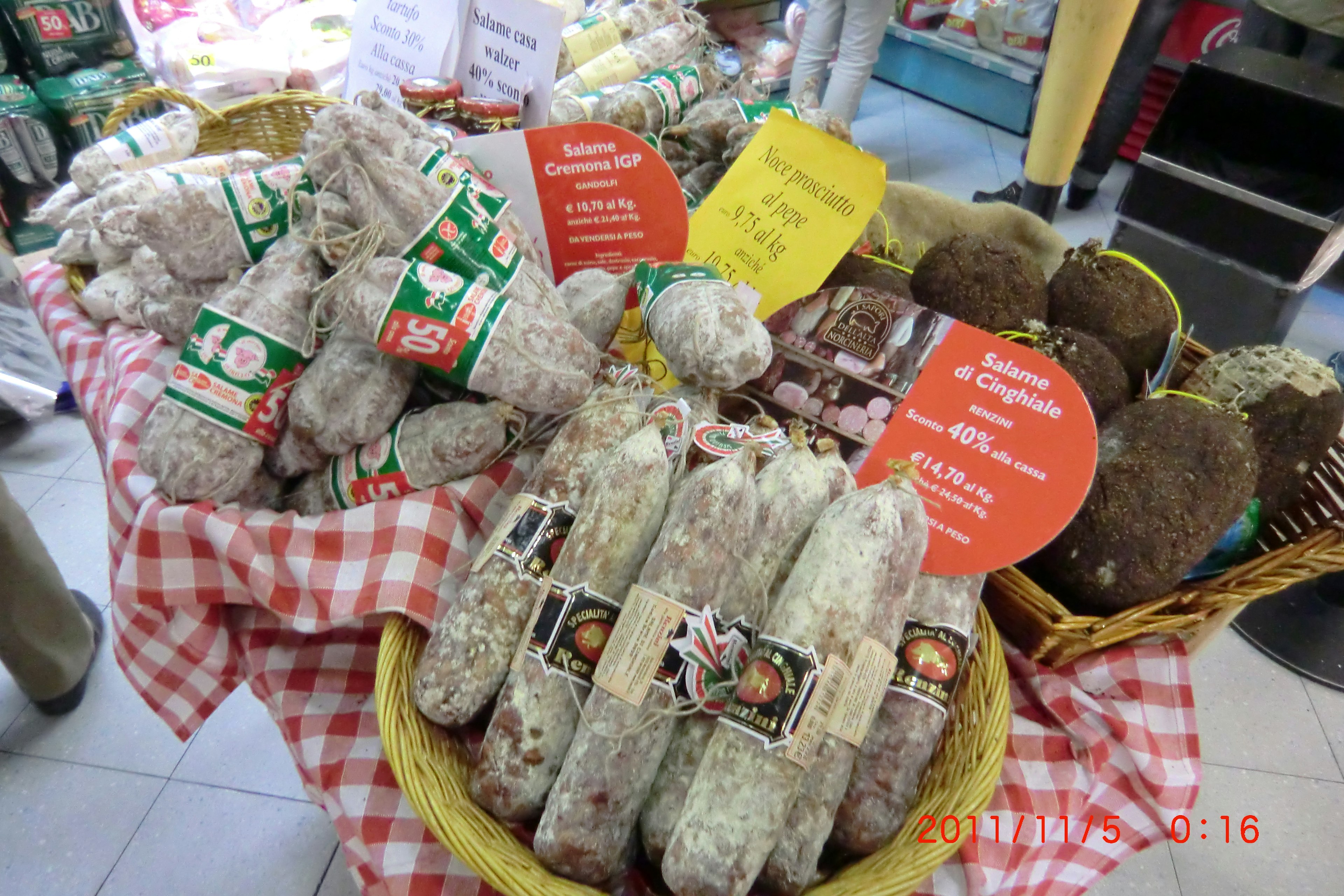 Baskets of various salami and cheese at a market