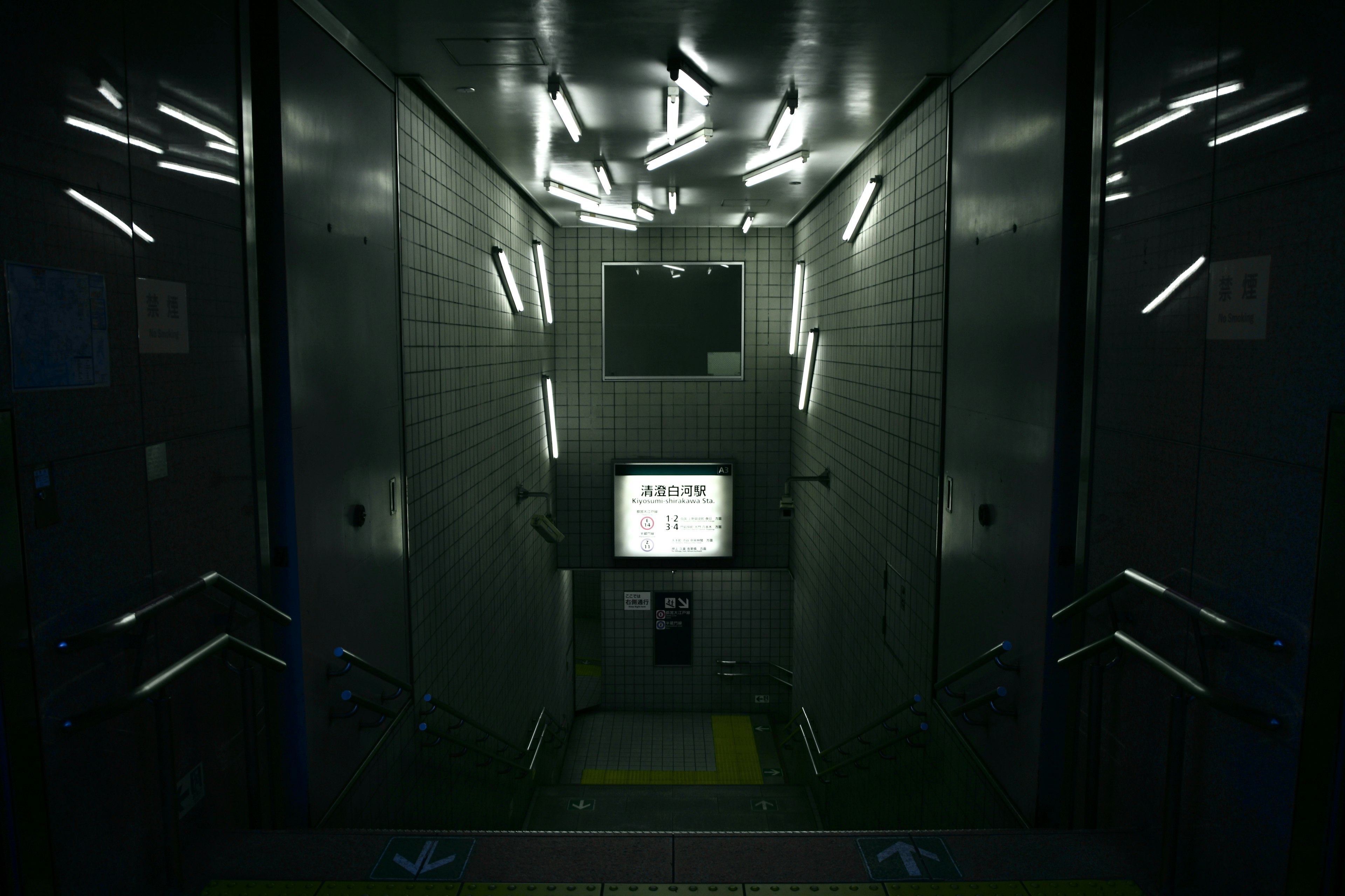 Interior of a dark elevator featuring a display and LED lights