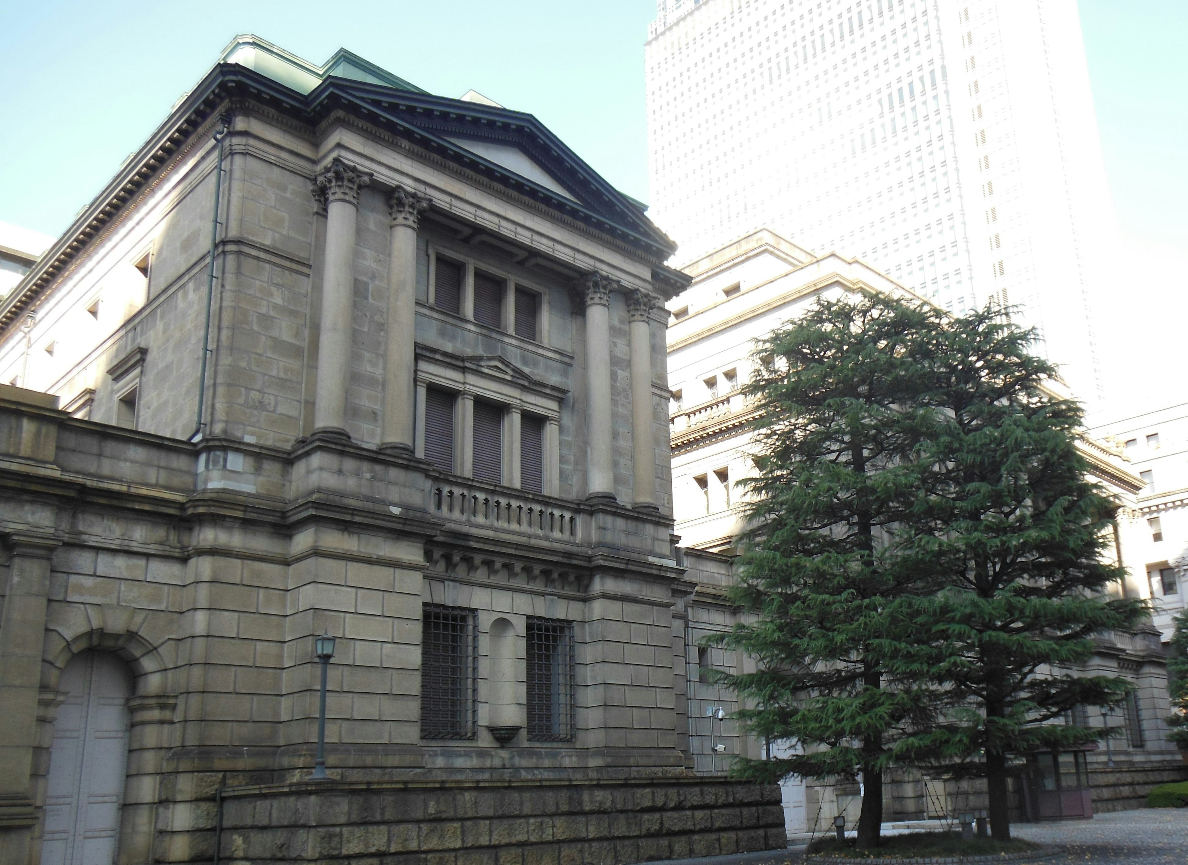 Historic building facade with modern skyscraper in background