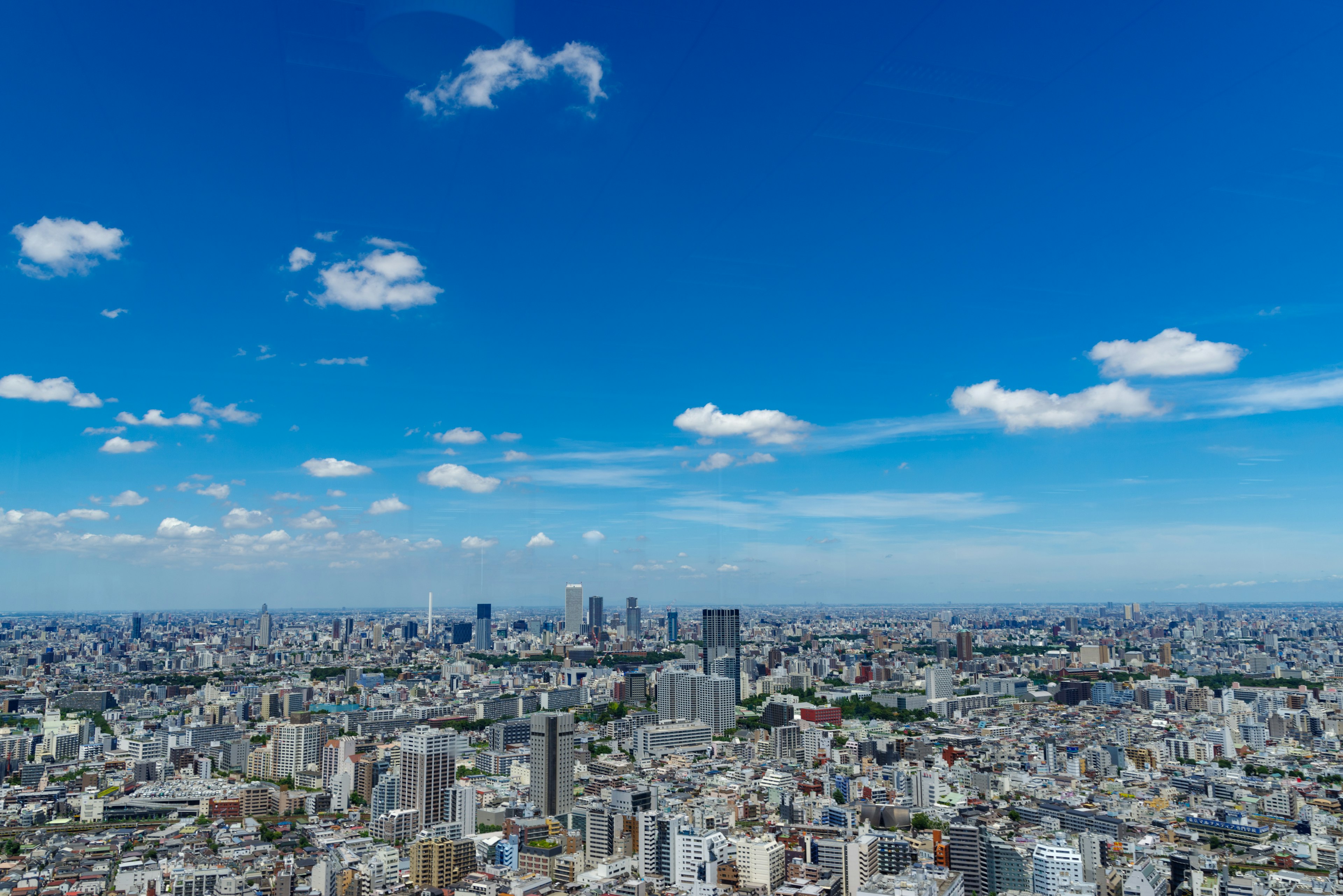 Panoramic cityscape with blue sky and scattered clouds