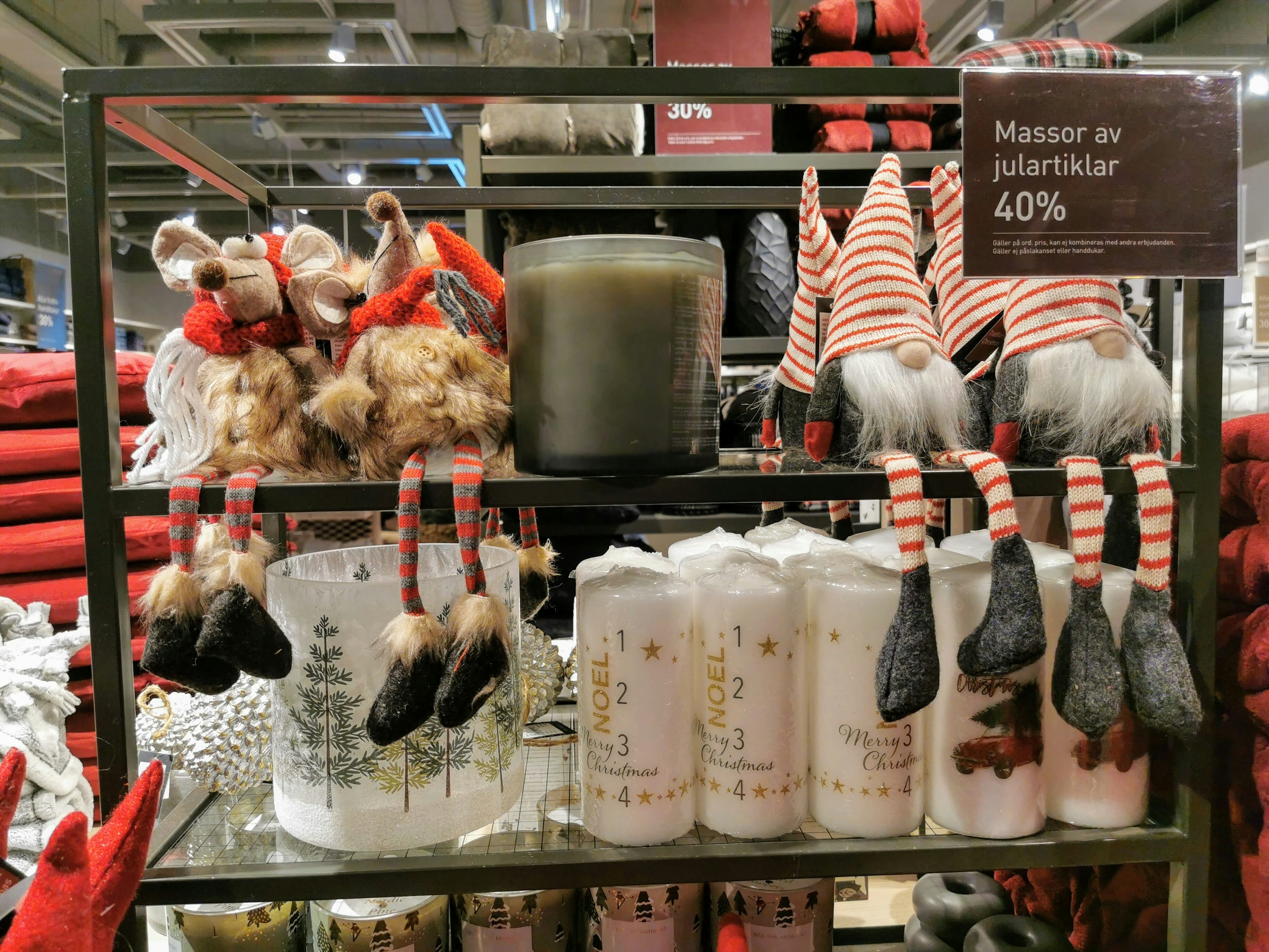 Shelves displaying Christmas decorations and candles