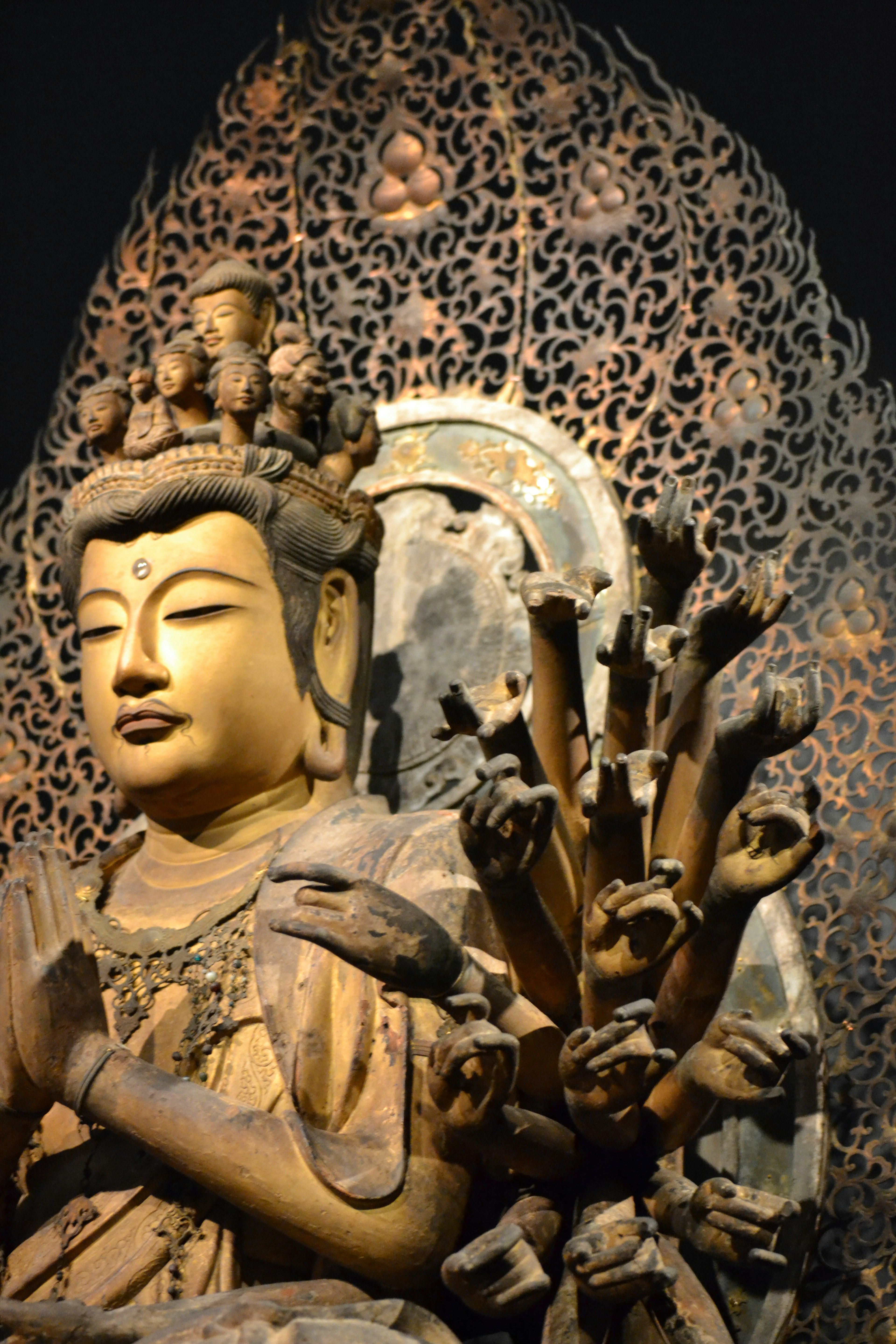 Golden Buddha statue with intricate background