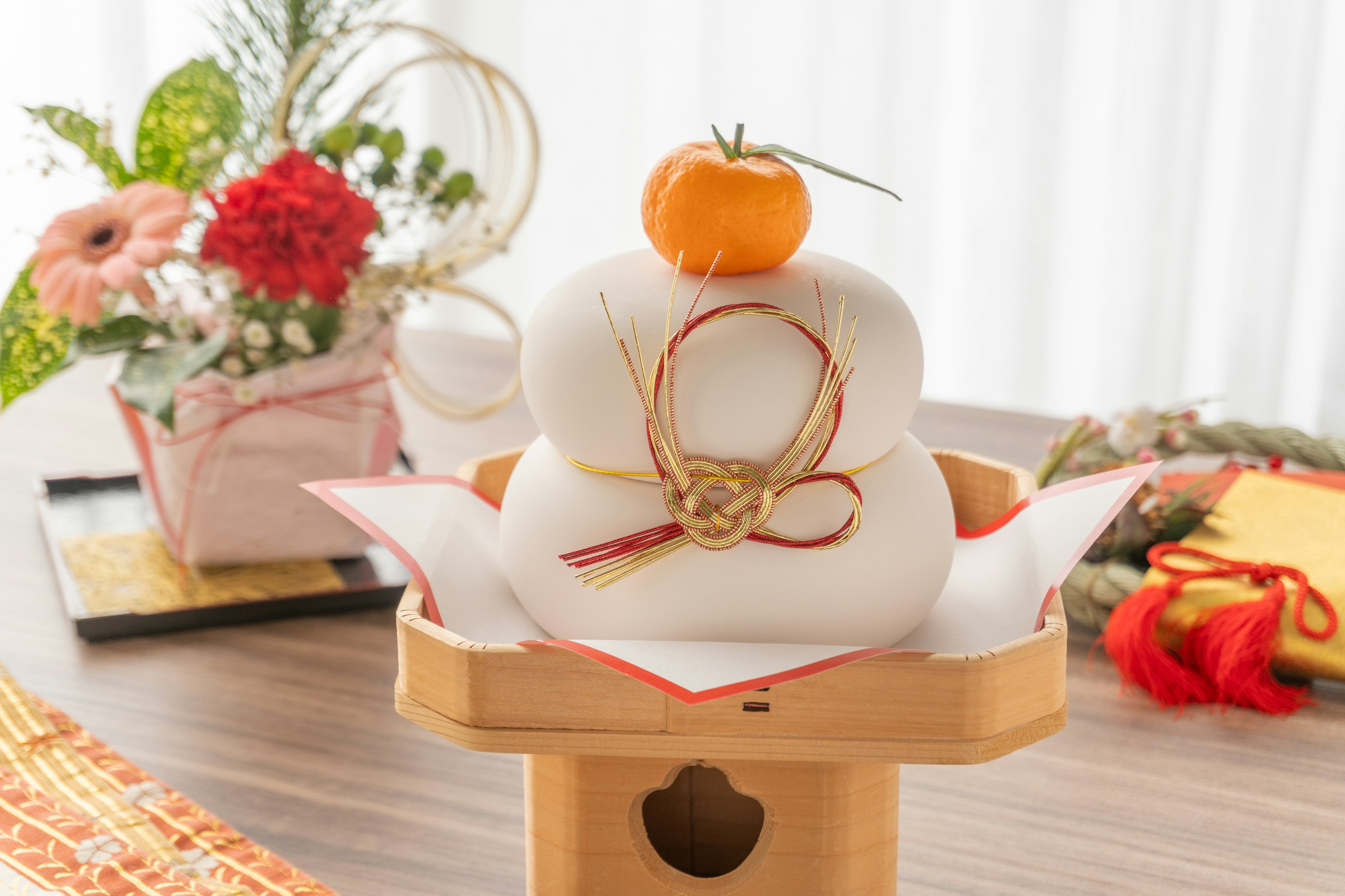 Traditional Kagami Mochi decoration with a tangerine on top