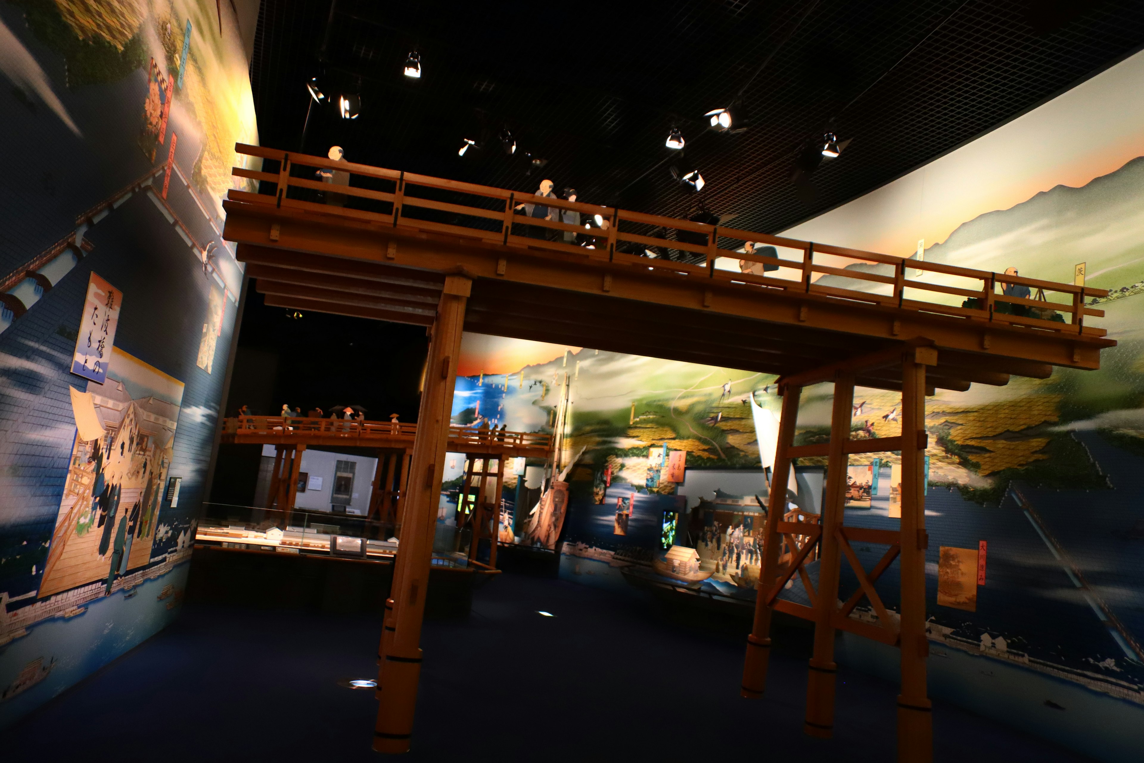 Wooden structure in an exhibition space with mural backgrounds